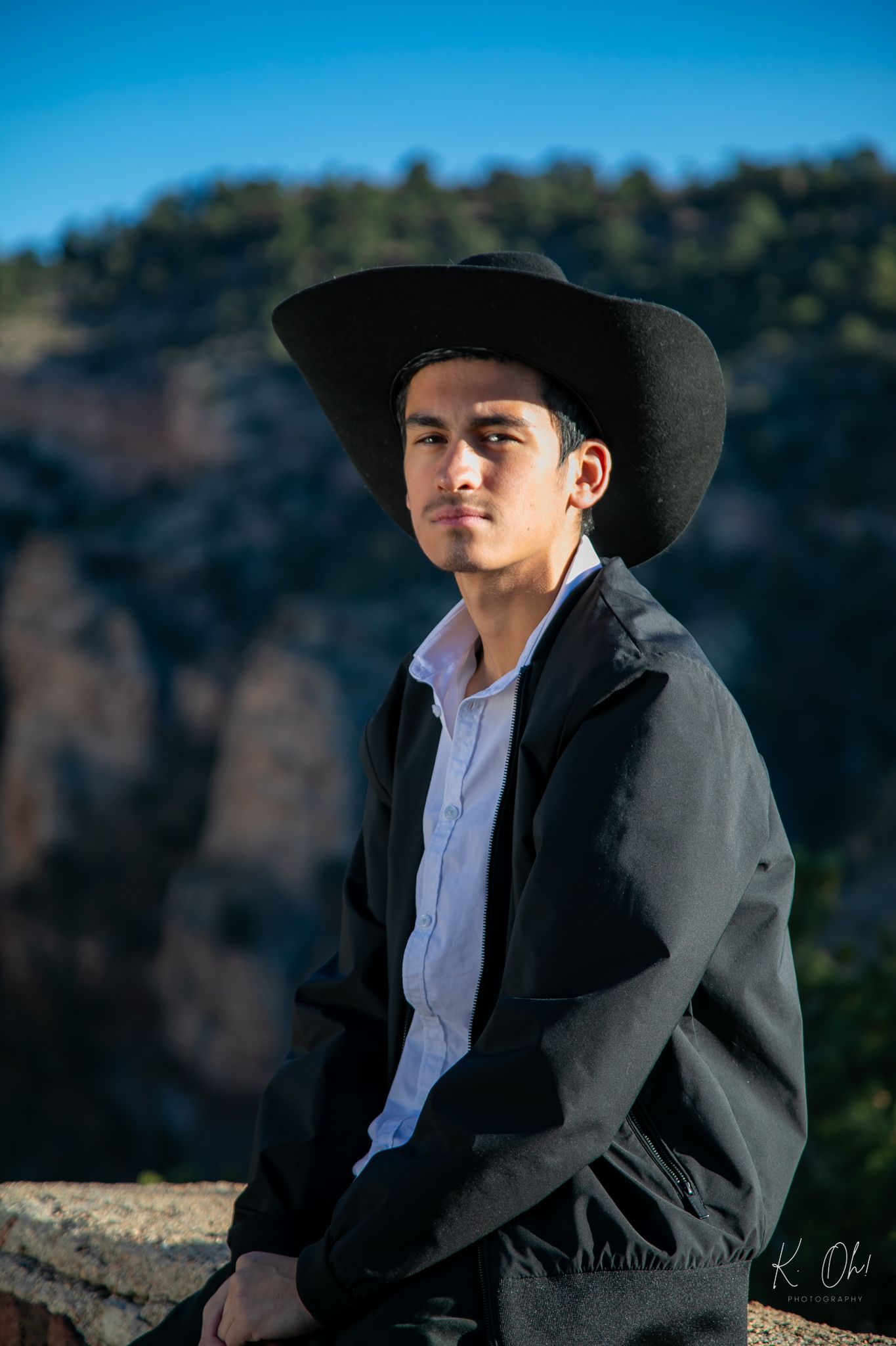 A series of portrait shots showing a person in western attire and black cowboy hat against a scenic mountain backdrop.