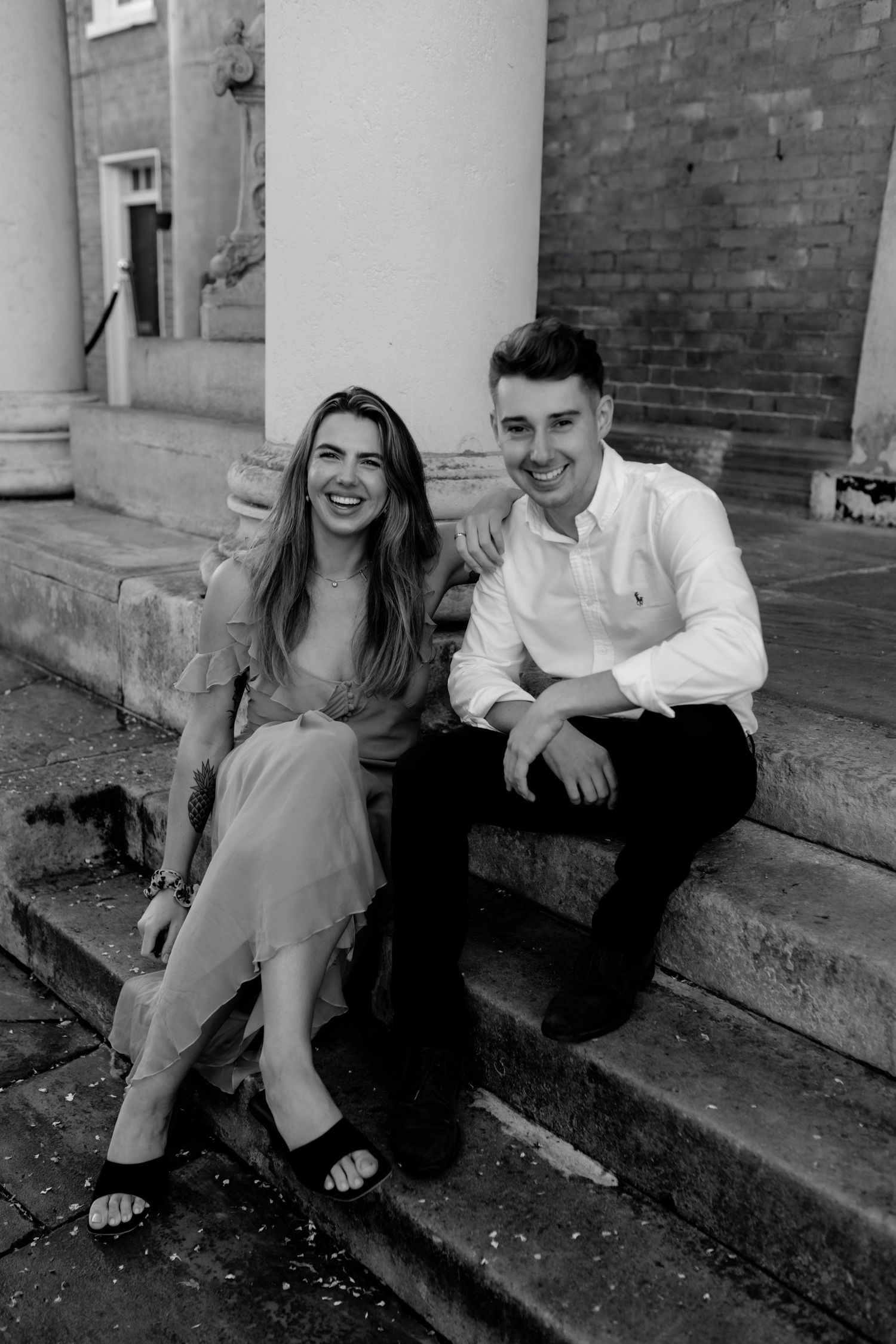 Casual portrait session showing people sitting and laughing on concrete steps.