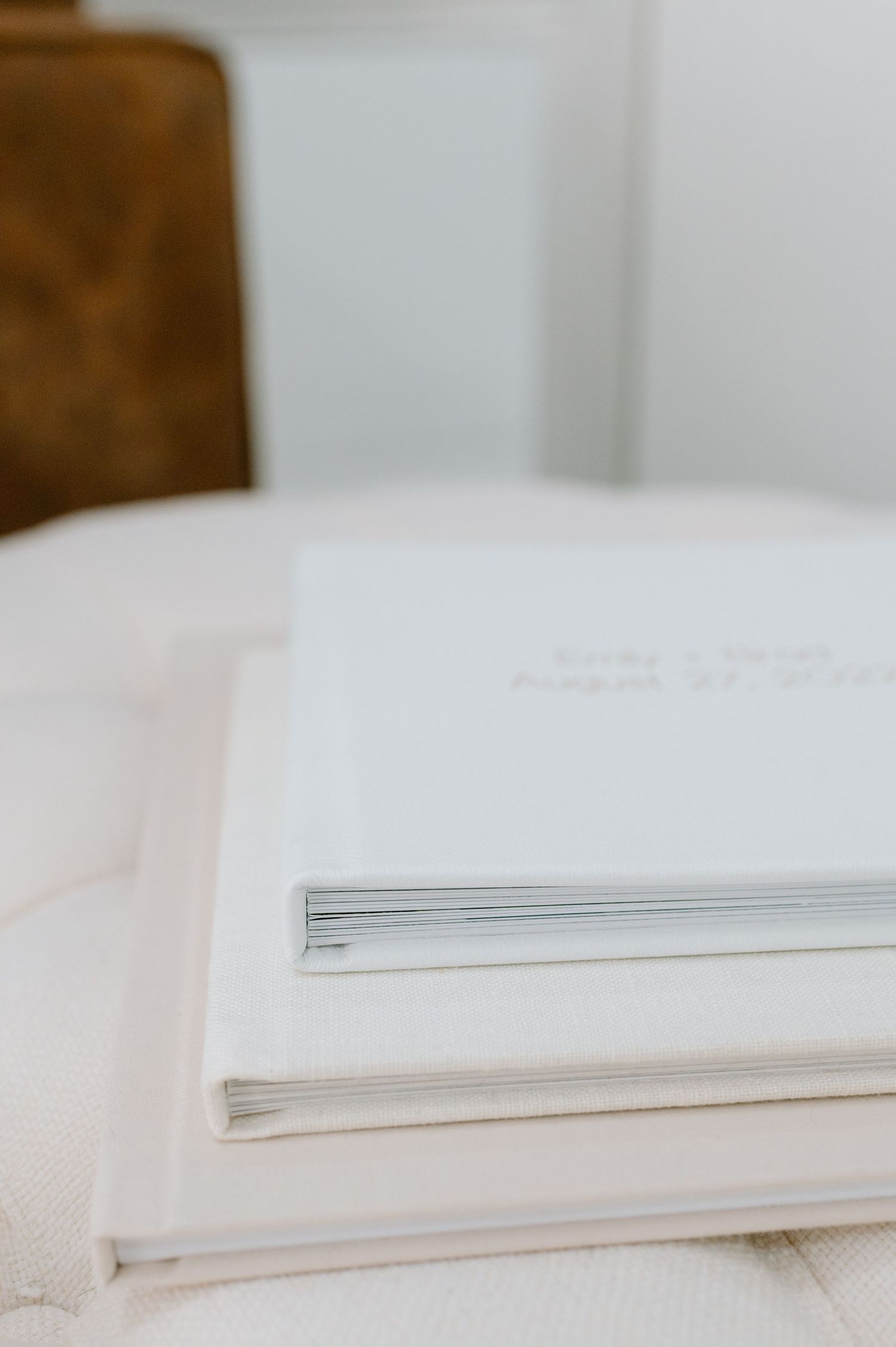 Stack of clean white papers or documents with soft edges resting on a white textured surface in natural light.