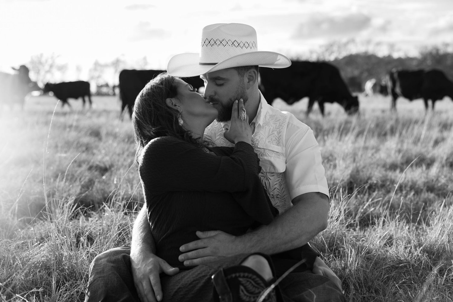 Black and white panoramic collage of ranch life showing cattle, cowboys, horseback riding and western scenery.