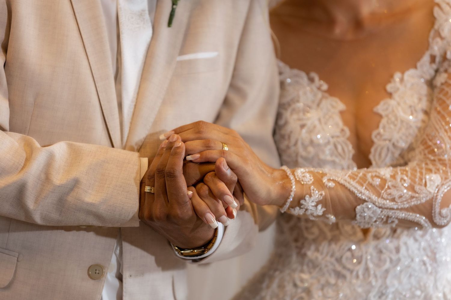 Close-up details of delicate white lace wedding dress.