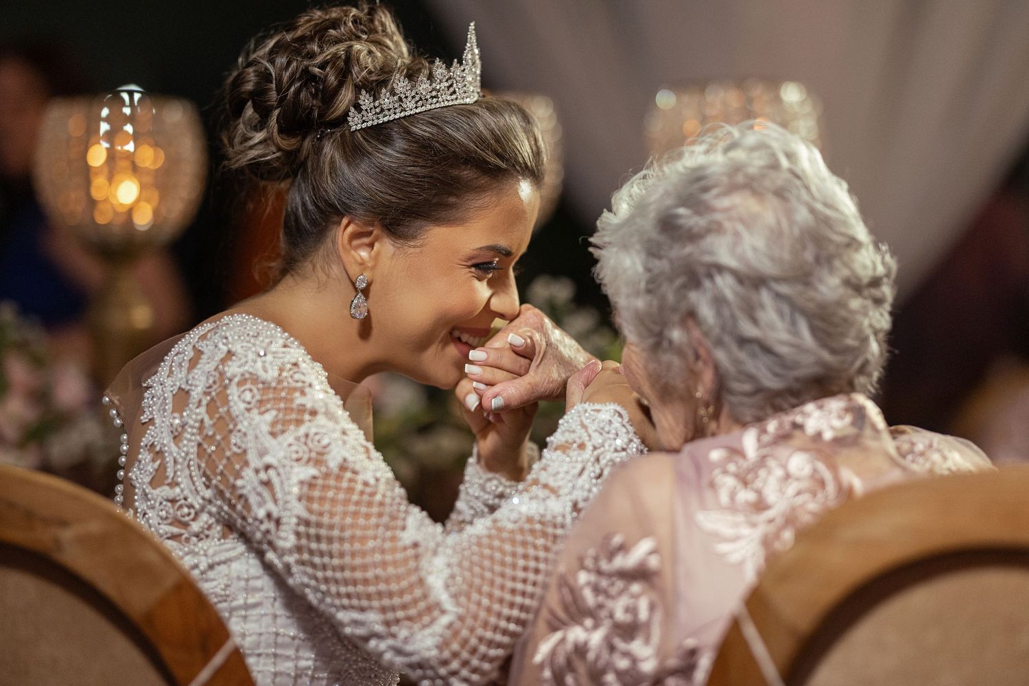 Intimate wedding ceremony moments showing affectionate embraces and laughter between a bride and her grandmother.