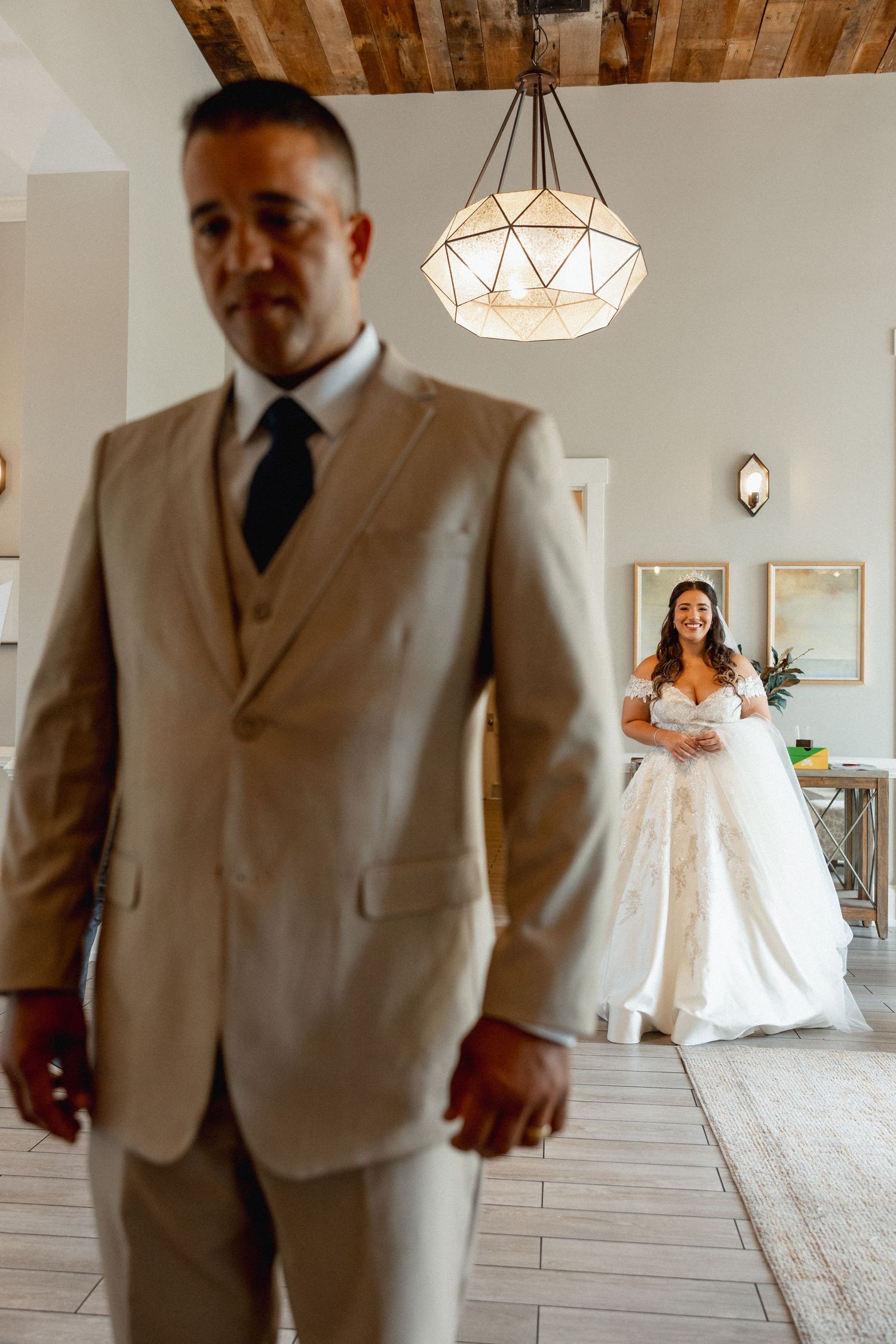 Bride in wedding dress holding back tears before emotional first look with her father in South Florida wedding
