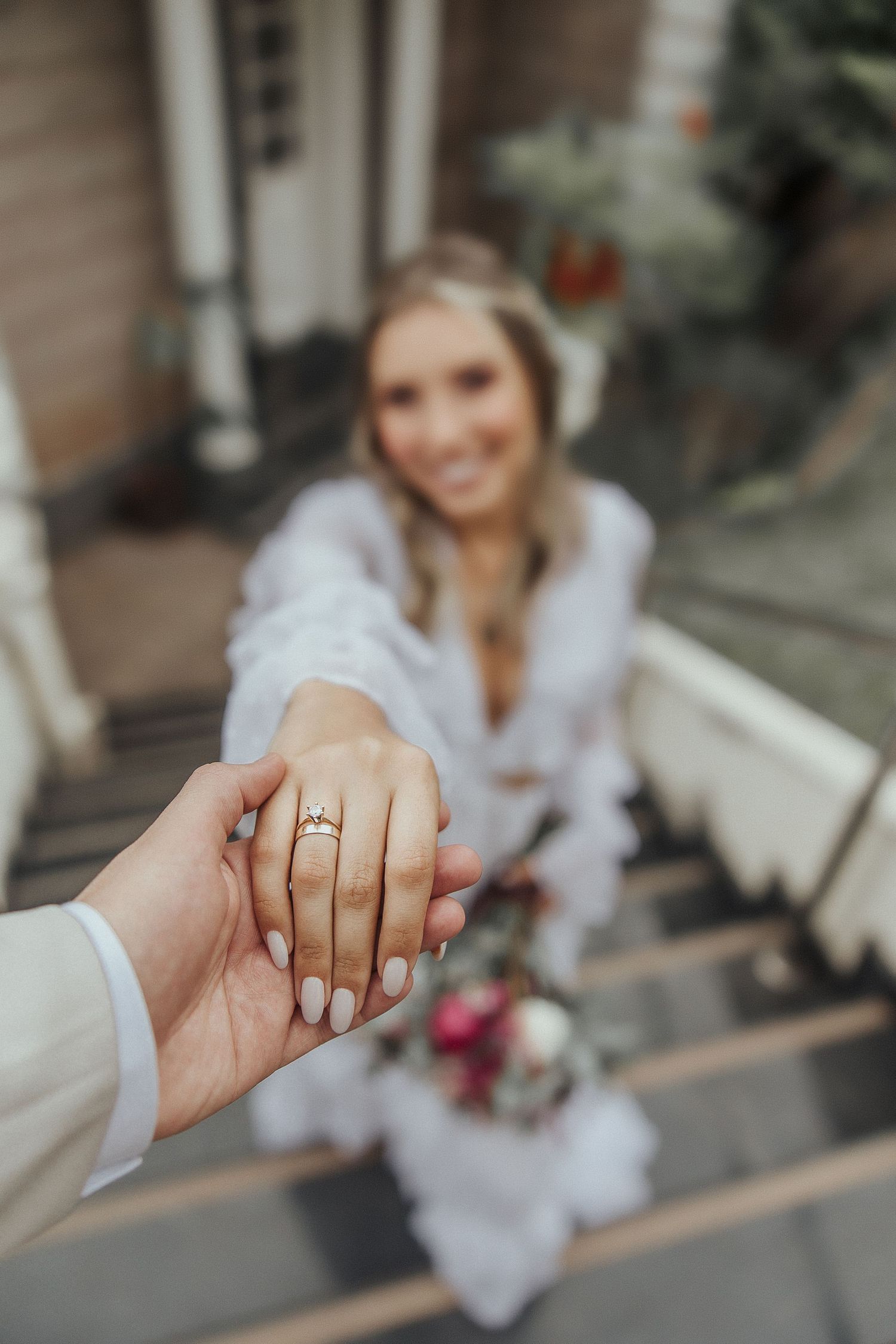 Close-up of groom holding bride’s ringed hand during wedding in Florida