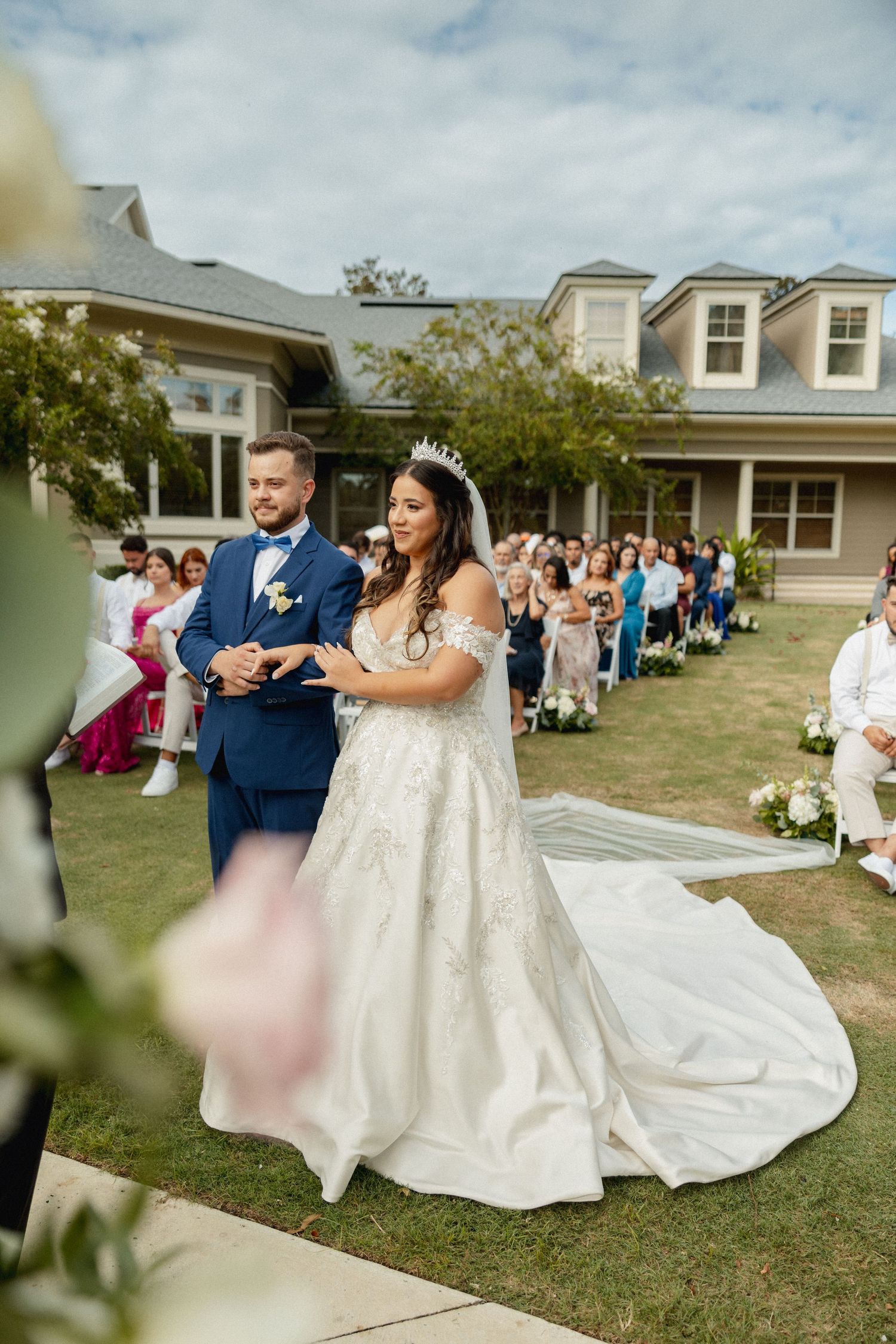 A wedding ceremony in a backyard setting with guests watching the couple dance.