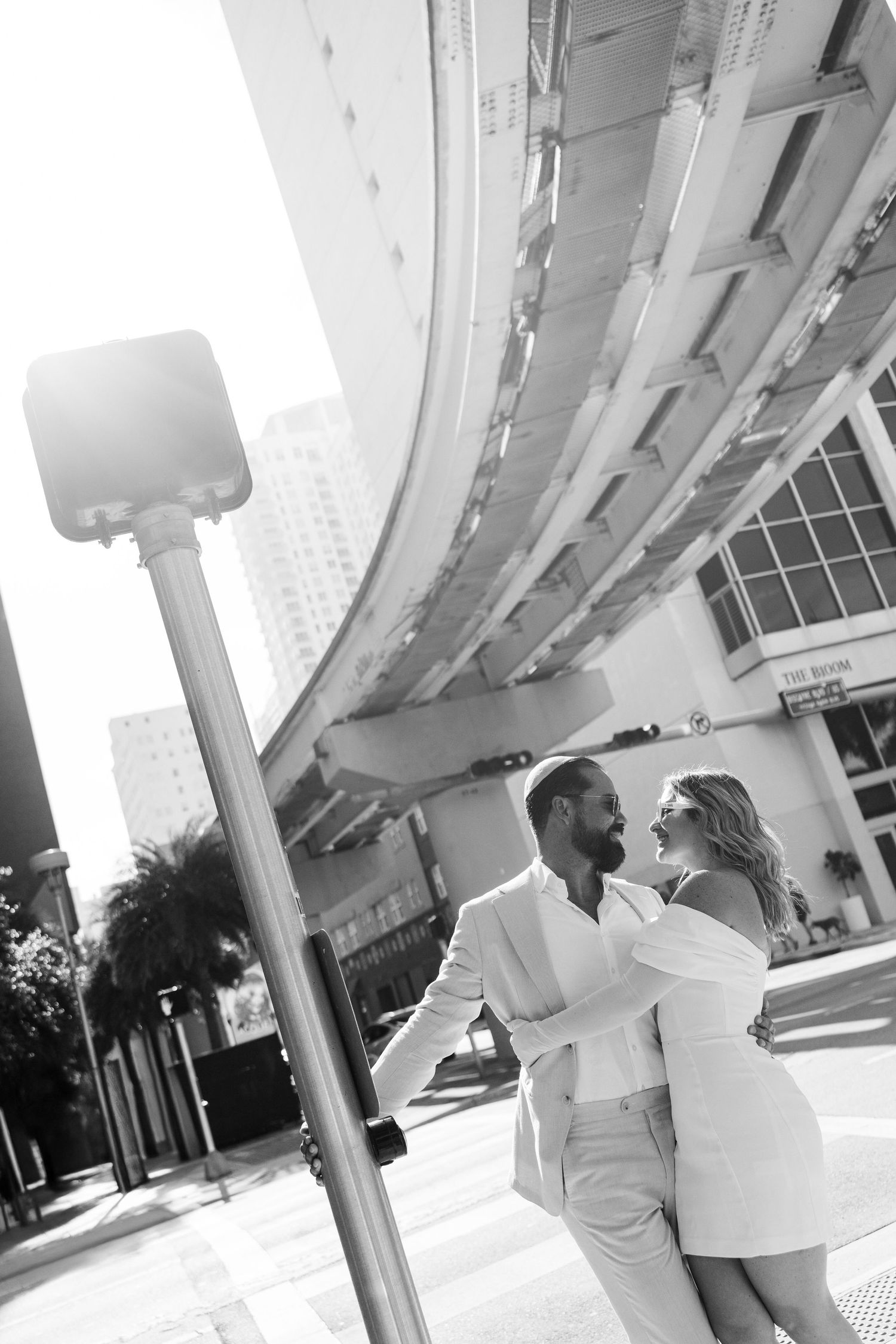 Black and white romantic photoshoot under modern architectural columns.