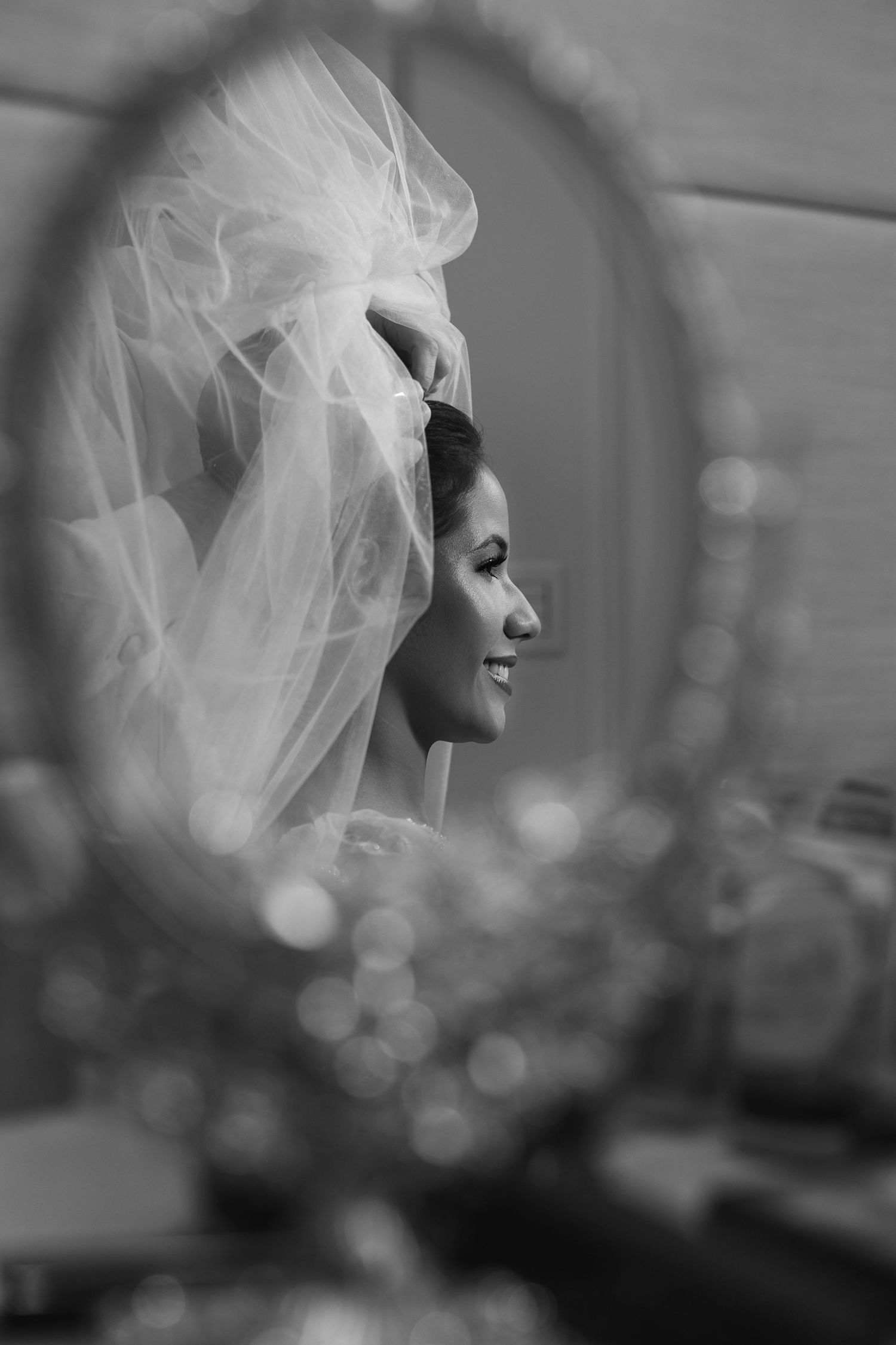 Artistic black and white photo with soft focus and flowing veil creating dreamy effect.