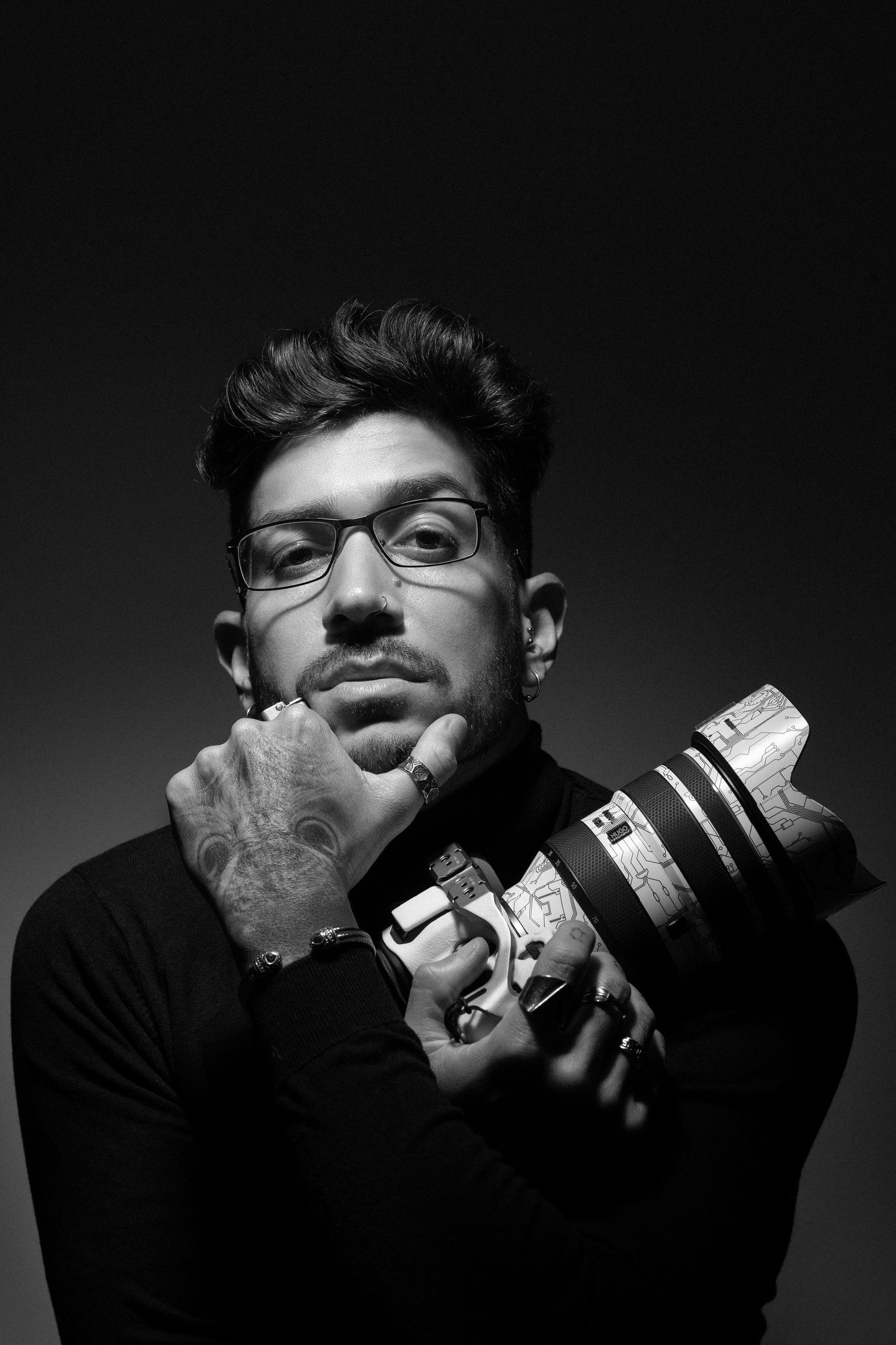 Dramatic black and white portrait series showing artistic poses with dramatic lighting.