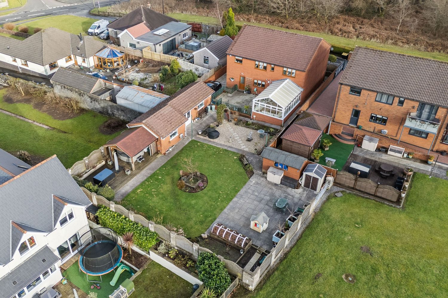Aerial view of residential properties with gardens and outdoor amenities. Llangyfelach, South Wales.