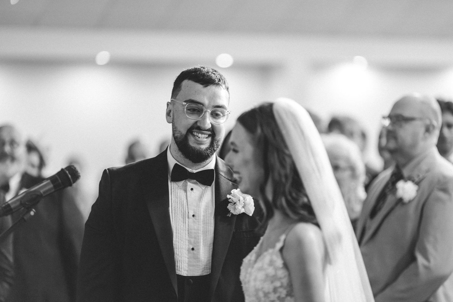 Black and white candid wedding ceremony moment captured with emotion and joy.