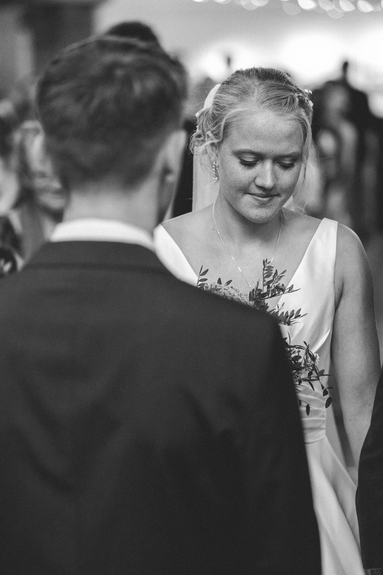 Intimate black and white moment of bride and groom during wedding ceremony.