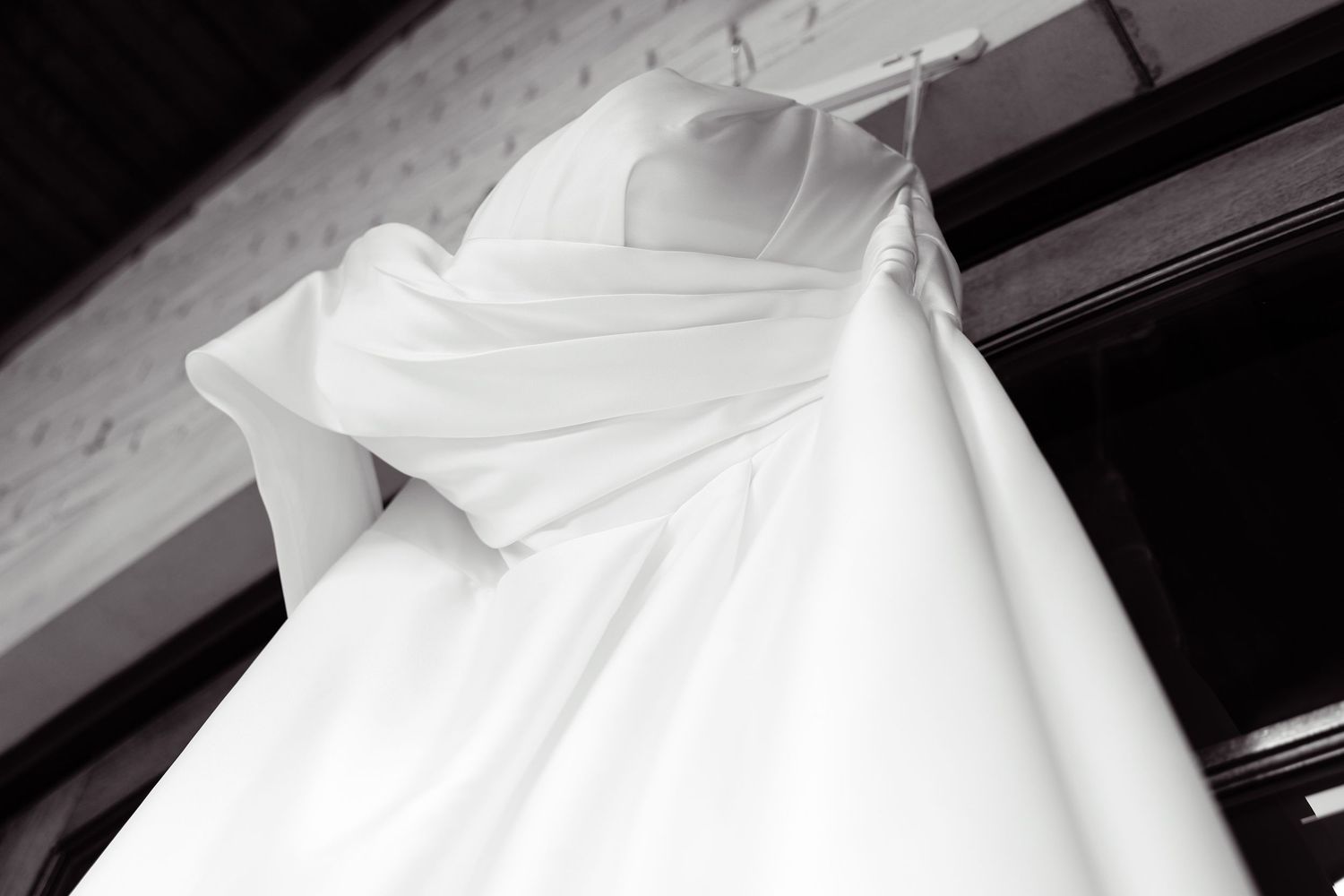 A close-up sequence showing white fabric being smoothed and arranged, possibly a wedding dress or formal gown.