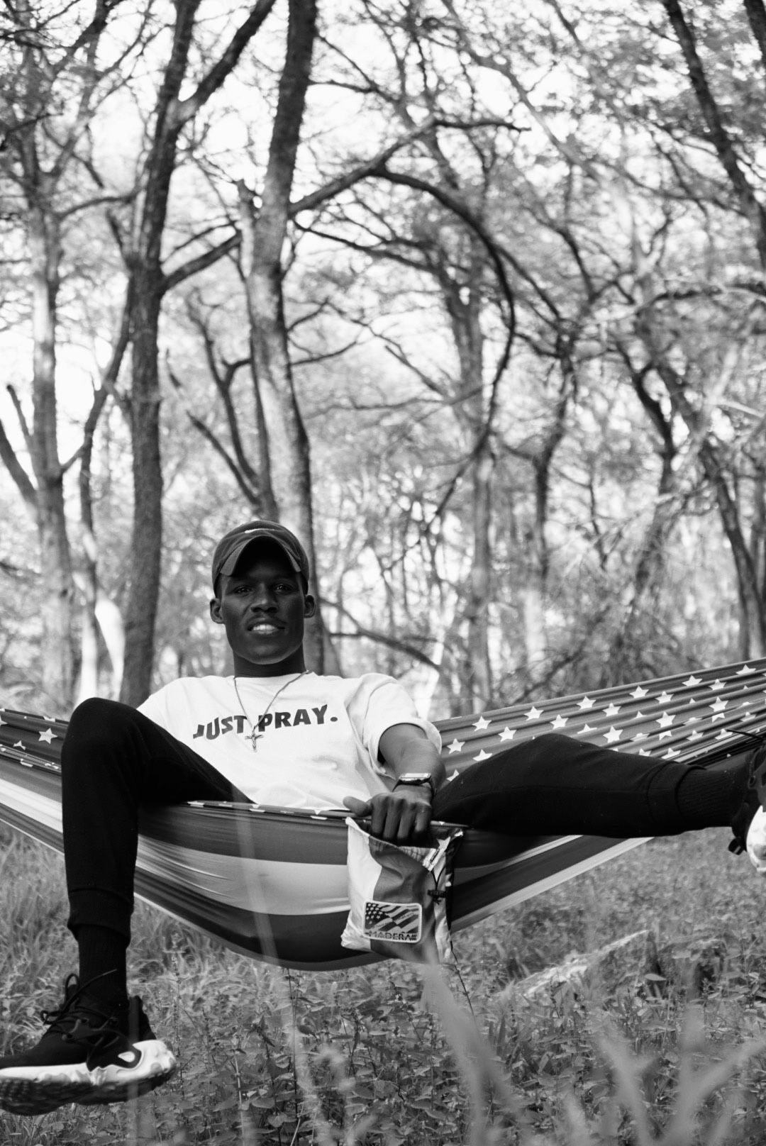 Black and white photo of person relaxing in hammock among trees in Stillhouse Park, adjacent to Stillhouse Lake, Belton TX 76513.