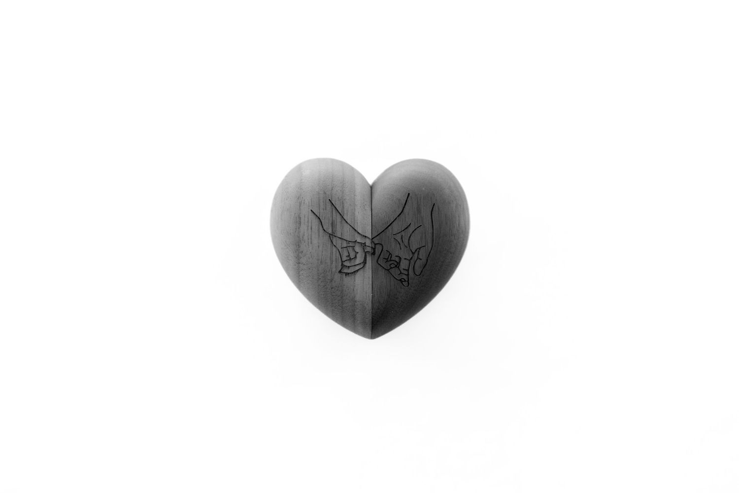 Two black heart shapes on a white background with a minimalist design style.
