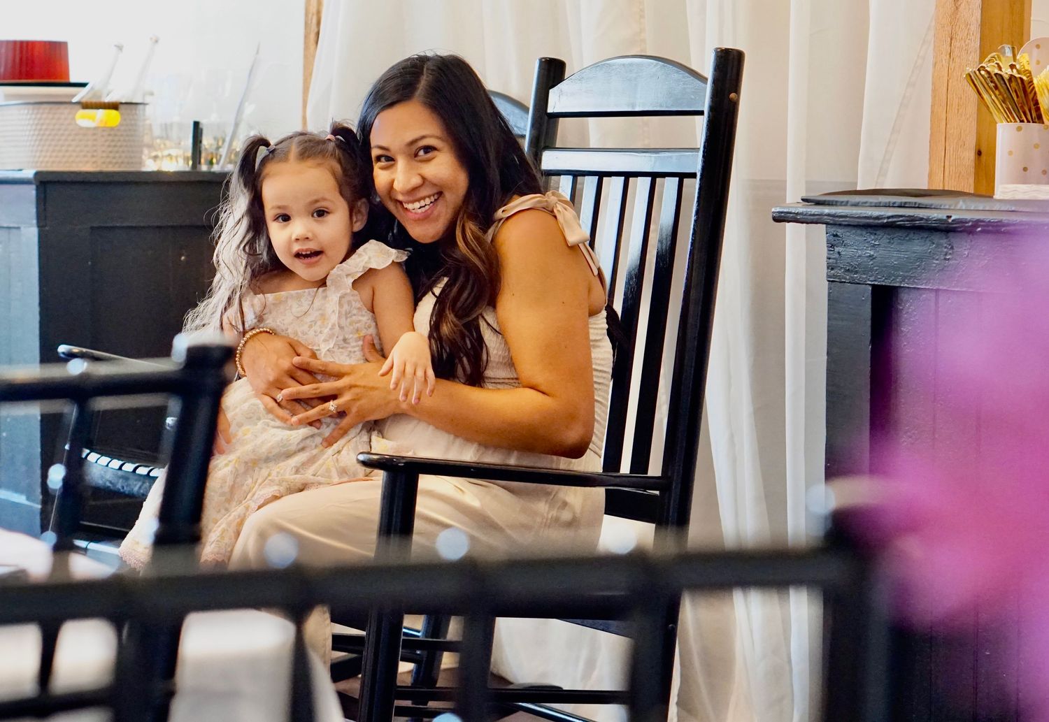 Candid moment captured in rocking chair showing warm interaction.
