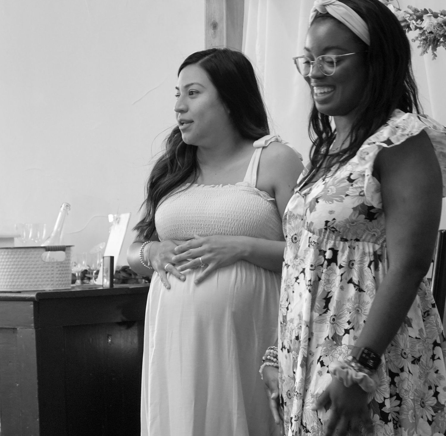 A series of candid black and white photos showing women in white and floral dresses at what appears to be a celebration.