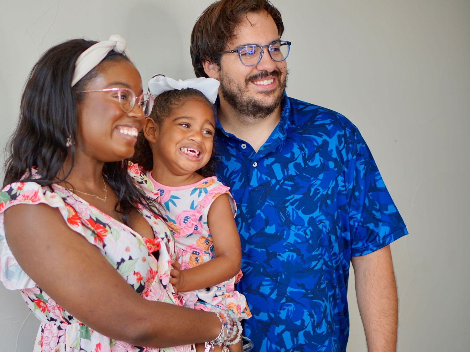 A happy family in coordinating blue and pink outfits shares joyful moments together in a photo collage.