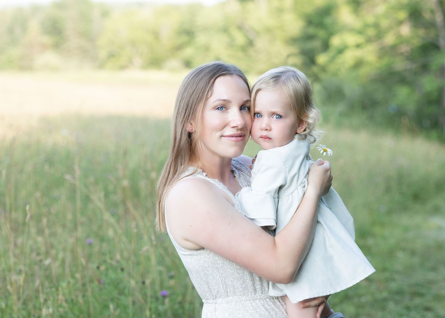 Mother holding child in a field