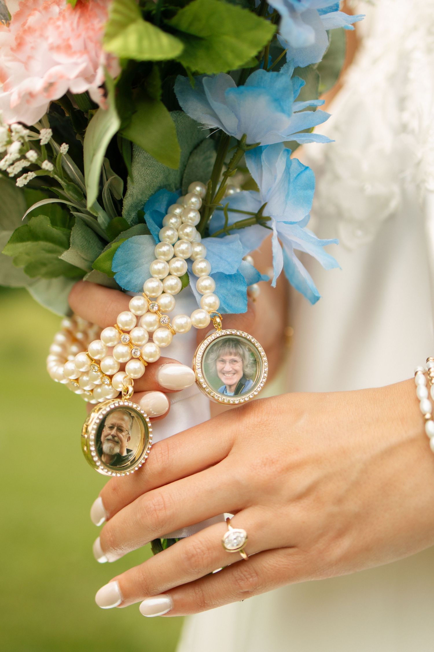 Bride holds a colorful bouquet with pearl bracelet and memorial photo charms honoring loved ones on her wedding day.