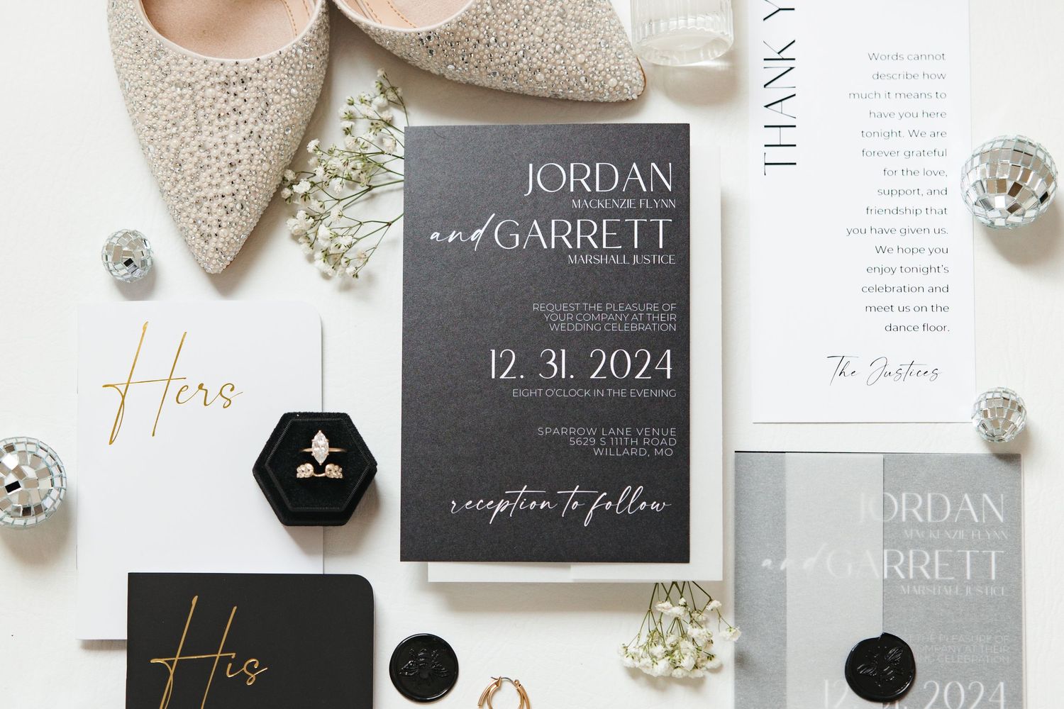Wedding invitation suite with Jordan and Garrett names displayed with beige shoes and floral details.