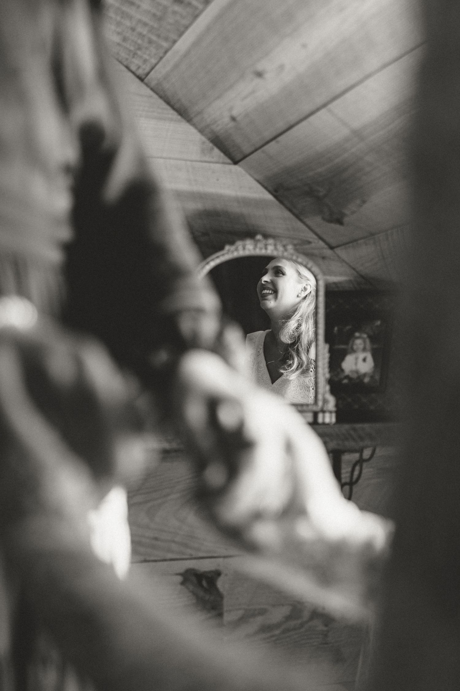 Artistic black and white photograph showing reflection in mirror with soft focus.