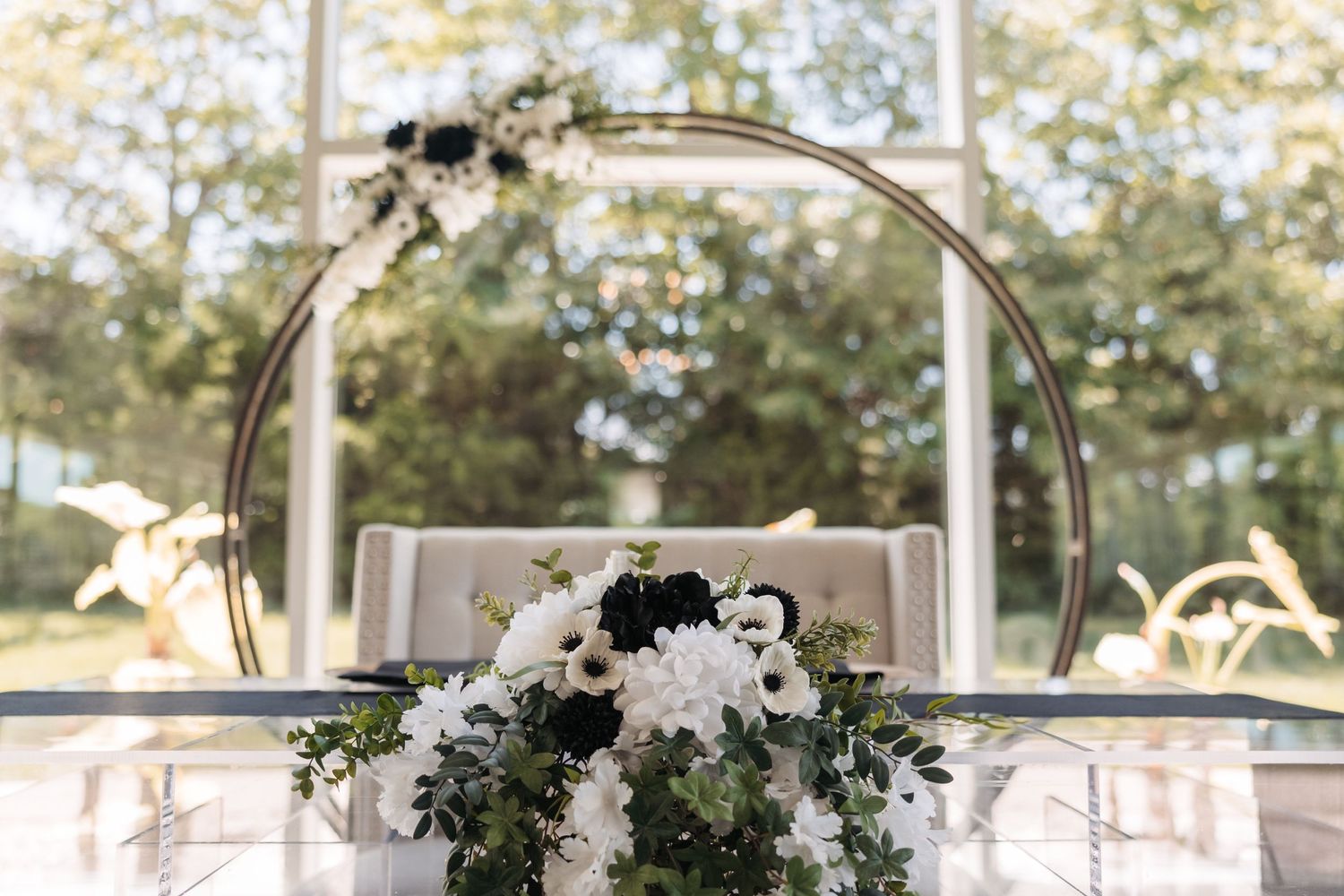 Modern round floral arch decorated with white and green flowers for a wedding ceremony.