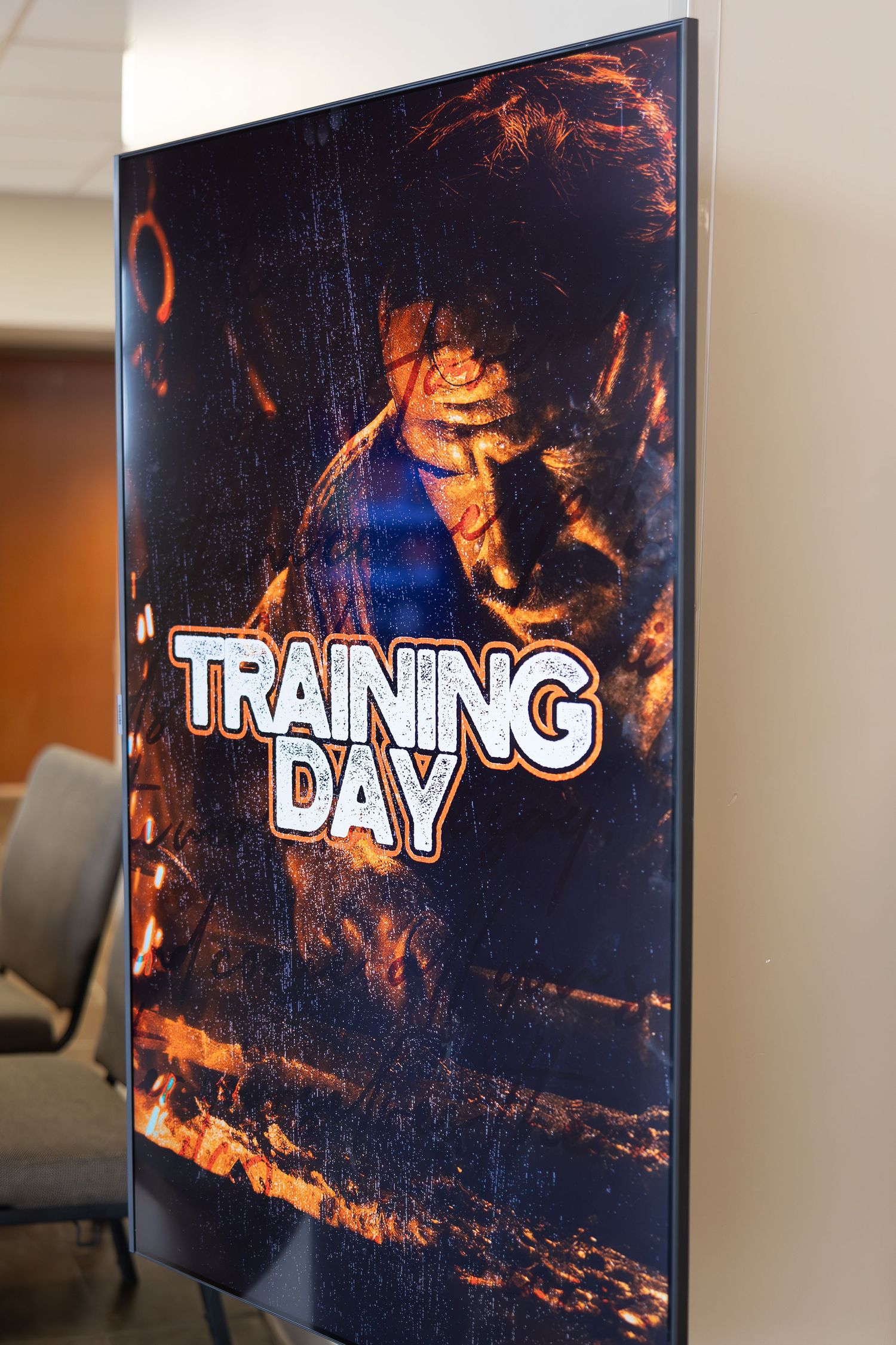A digital display shows 'Training Day' text on a dark background with dramatic orange lighting effects.