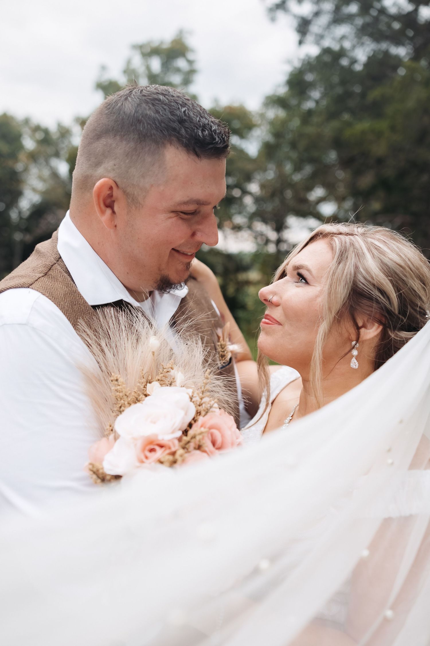 A tender wedding moment captured as the couple shares an intimate glance.