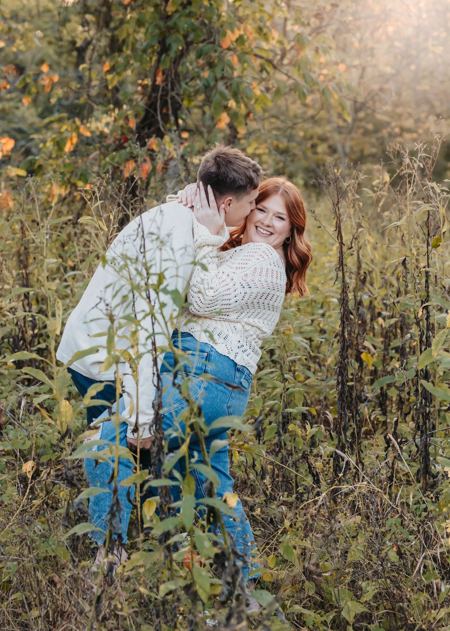 Sweet embrace photographed among autumn foliage at sunset.