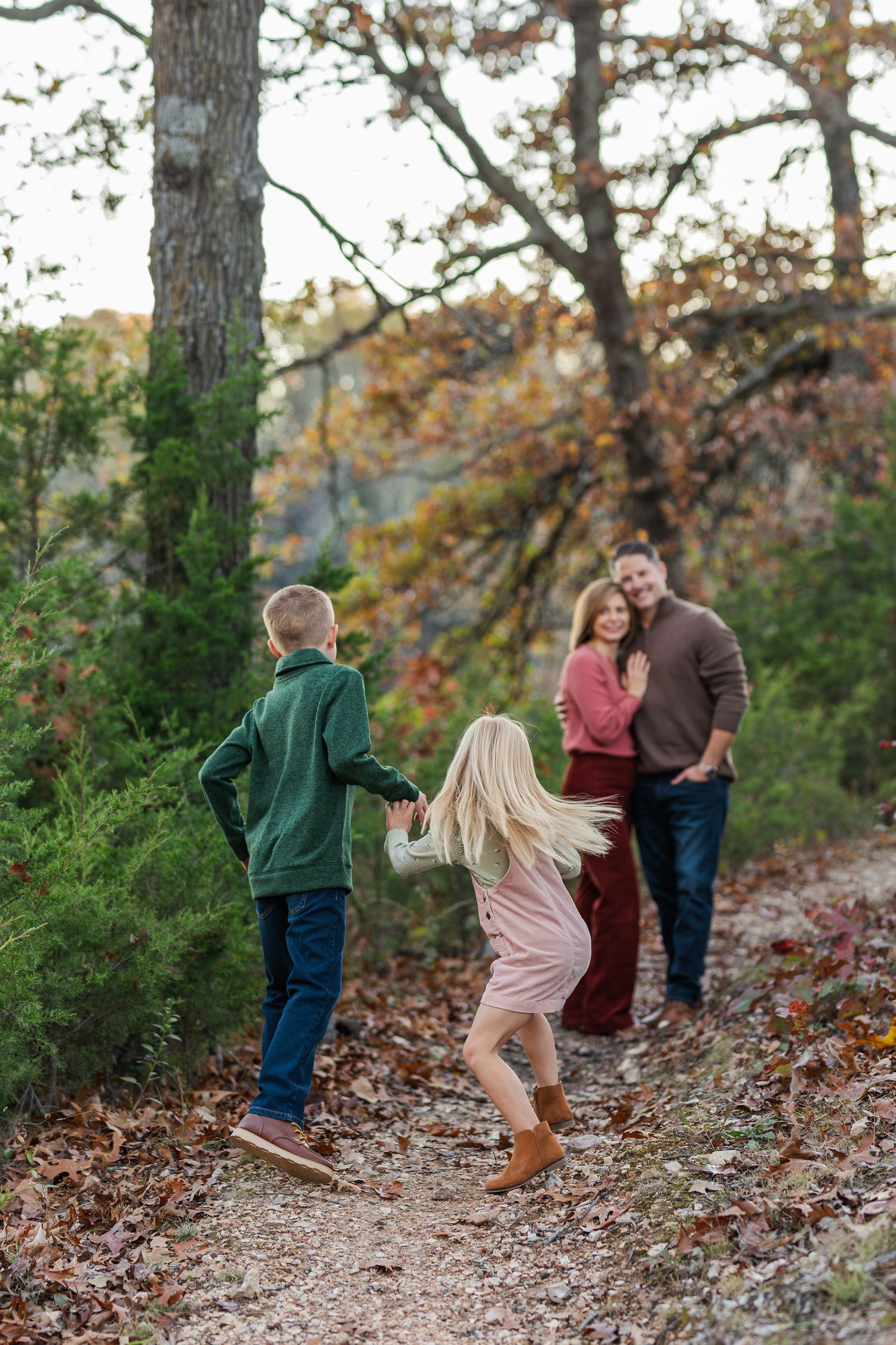 Family enjoying outdoor walk together on scenic autumn trail.