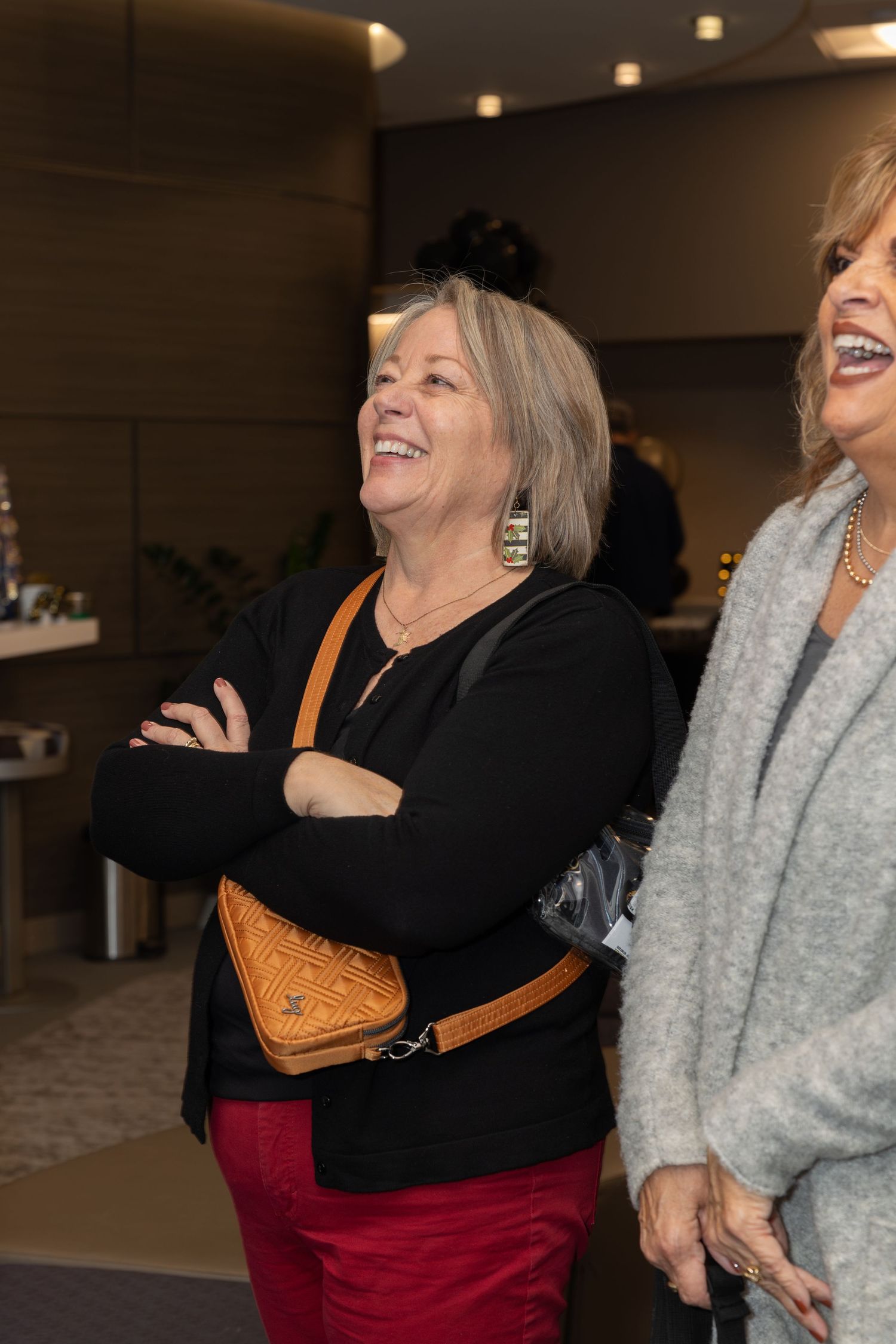 Candid shot of attendees laughing during a 50th anniversary celebration event.