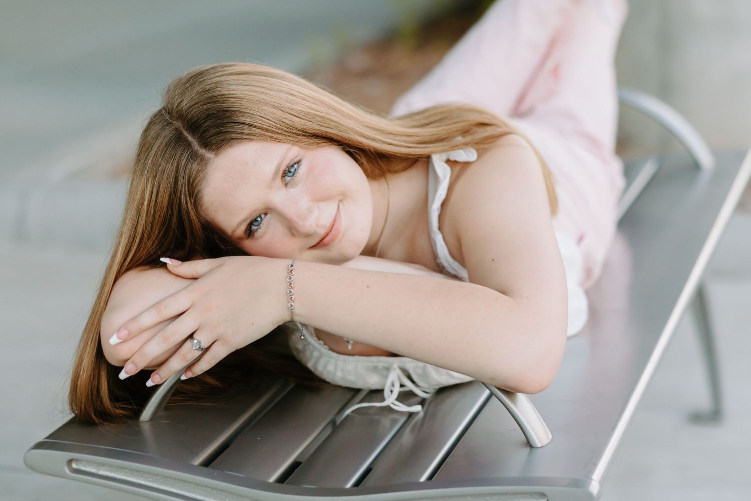 Person wearing a pink sweater lying down on a wooden surface in various relaxed poses.