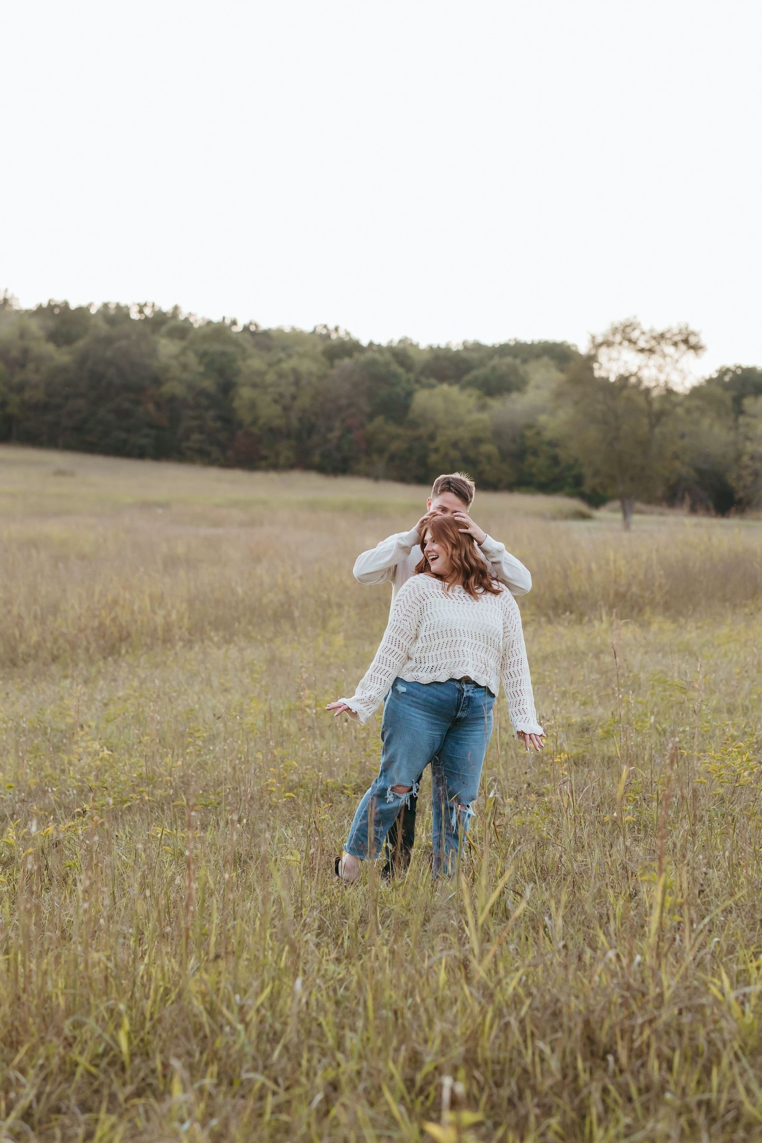 Playful moment captured in a golden field during autumn.