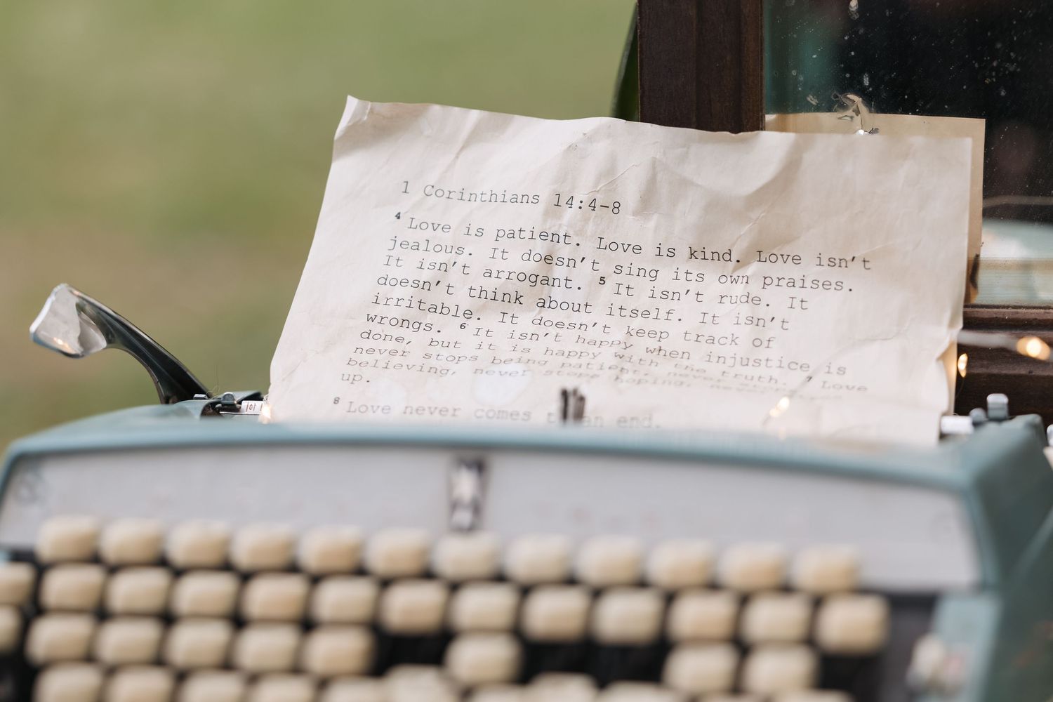 Vintage typewriter with a handwritten note inserted displaying text on white paper.