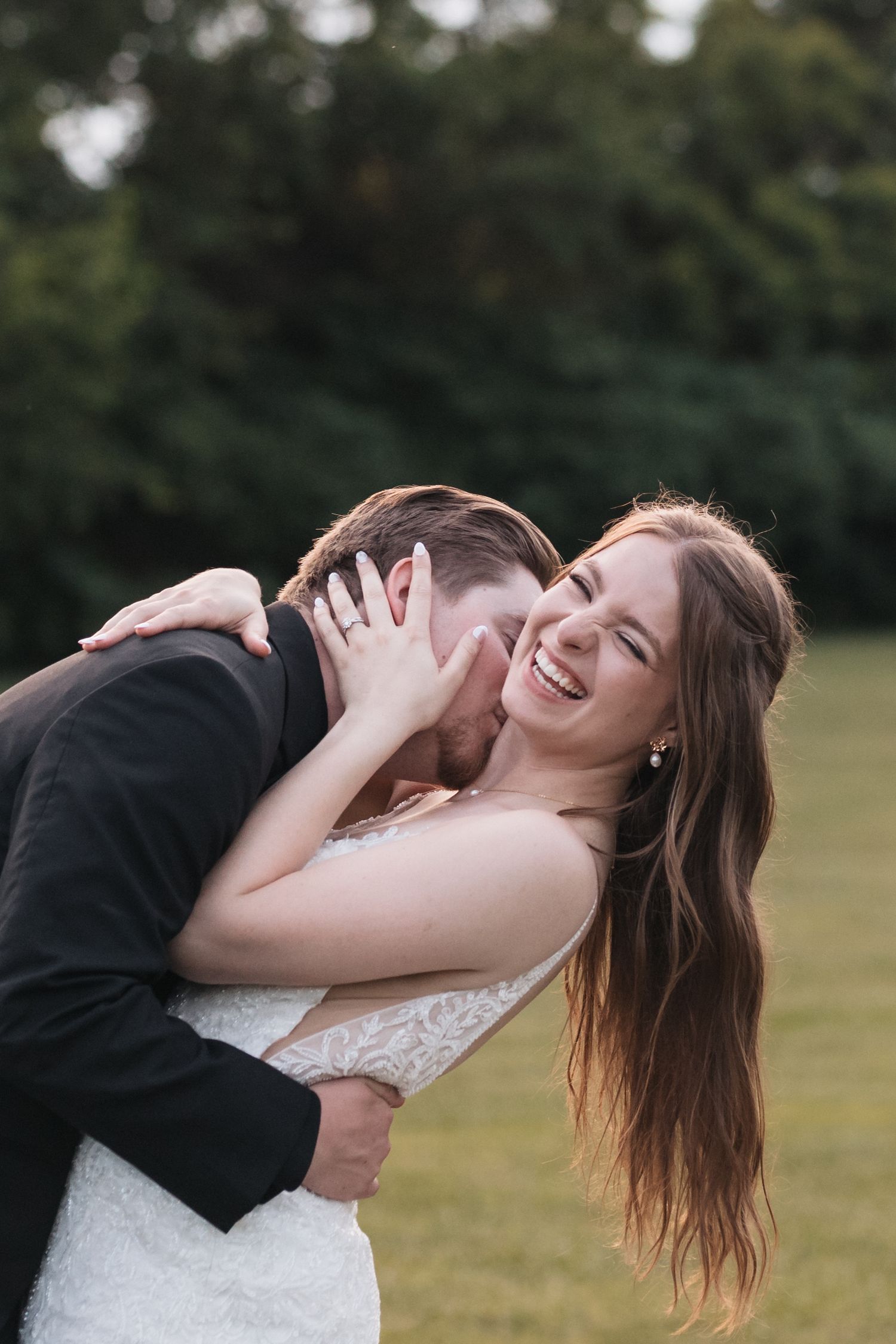 A couple shares a playful moment in formal attire on their wedding day.