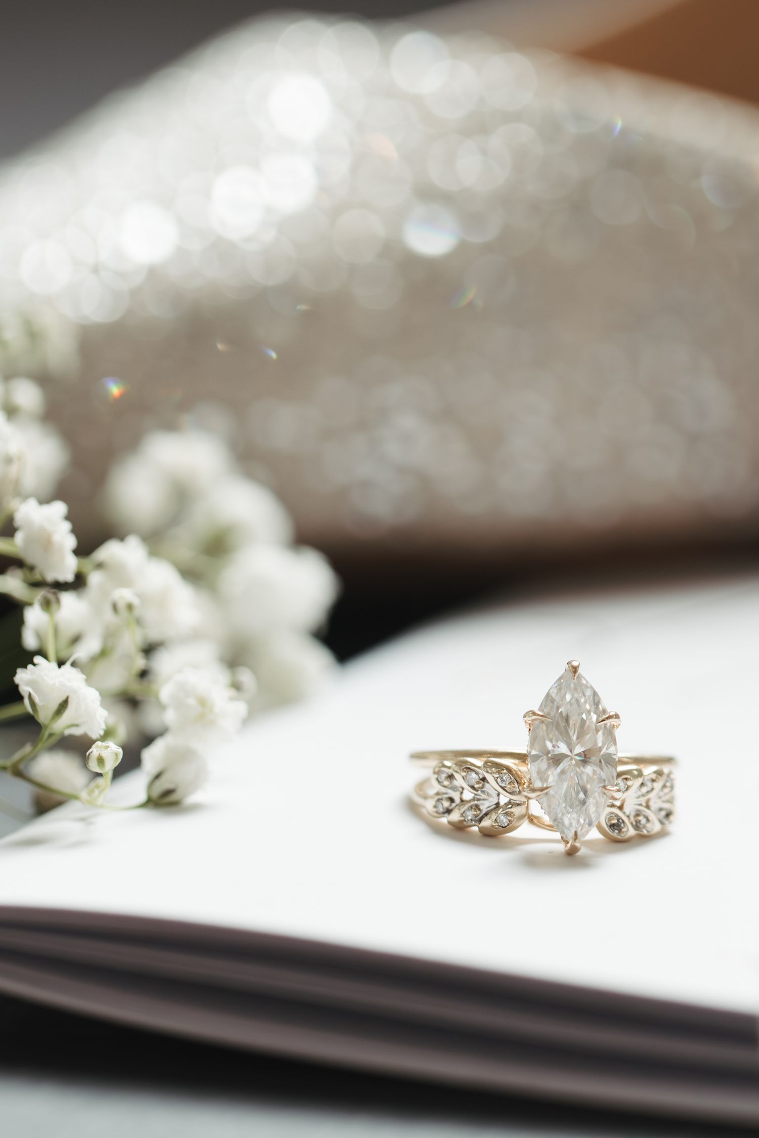 Beautiful engagement ring with baby's breath flowers in soft focus.
