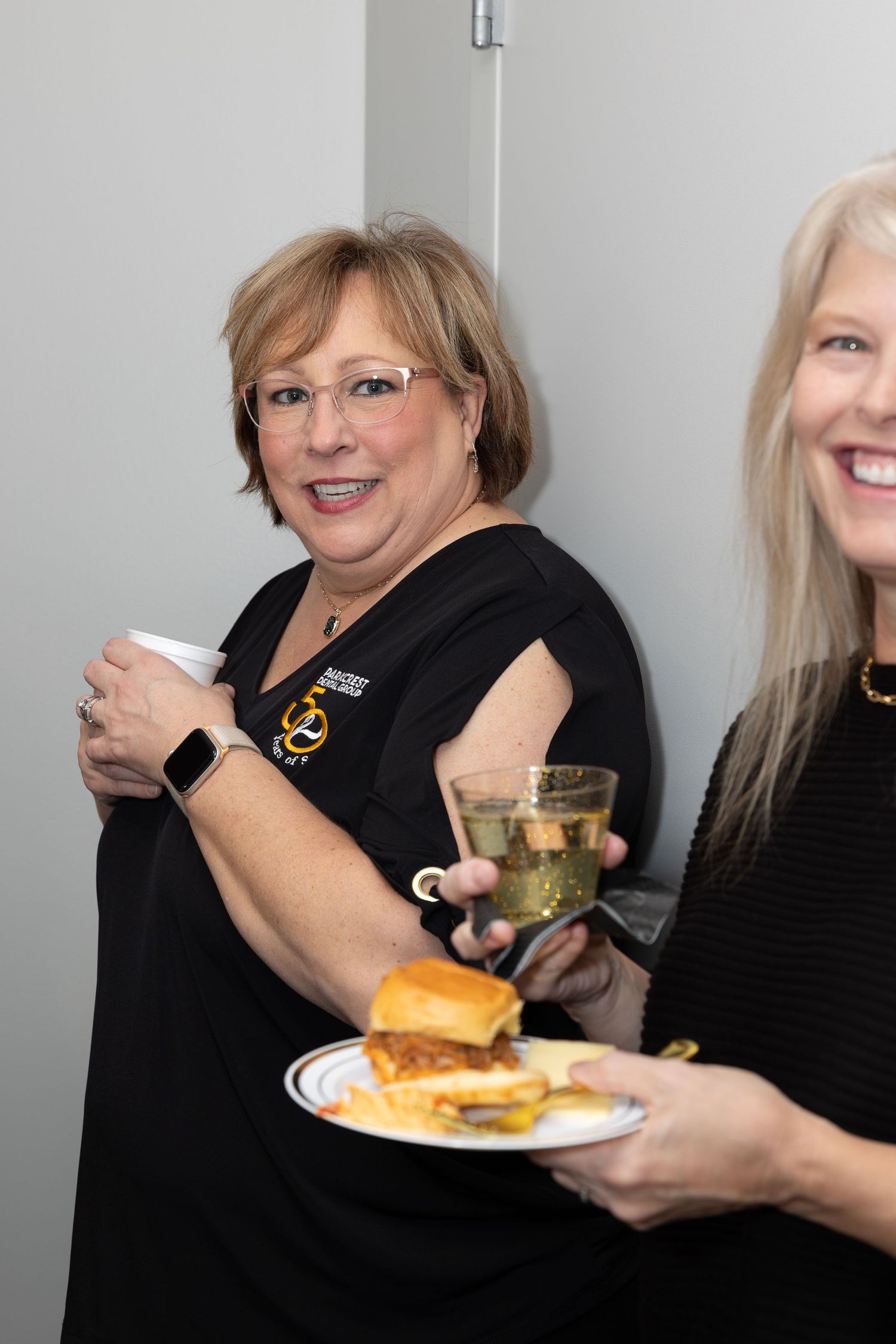 Staff members enjoying refreshments and appetizers at a social gathering.