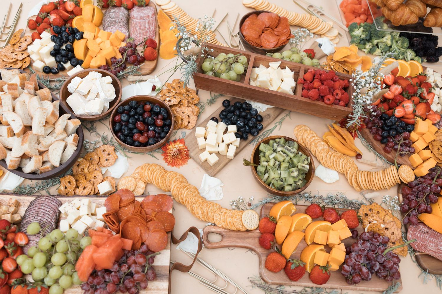 Luxurious charcuterie board spread with fruits, meats, cheeses and snacks.