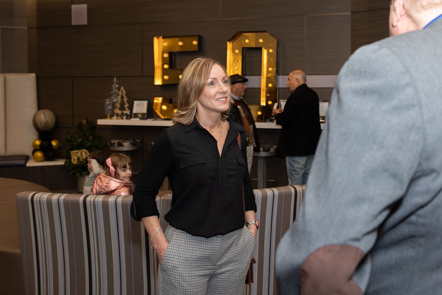 Professional engaging in conversation during networking event.