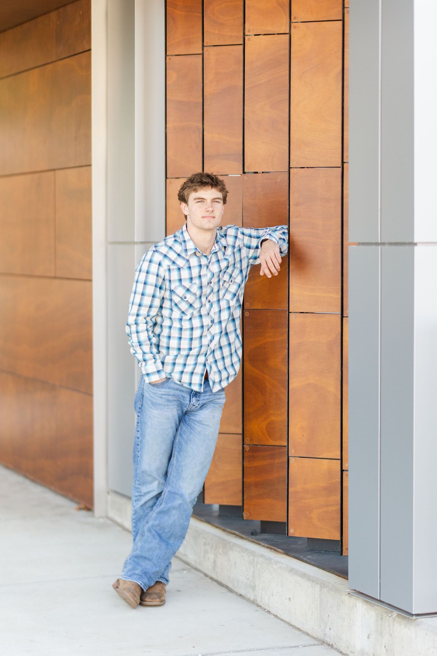 A casual outfit against modern architectural panels featuring copper-colored geometric walls.