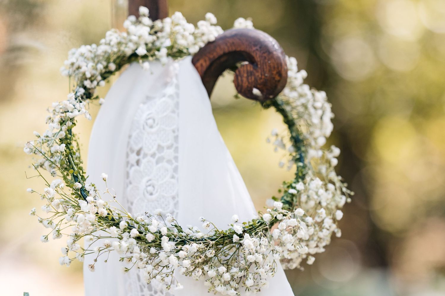 Delicate baby's breath flower crown with white lace details.