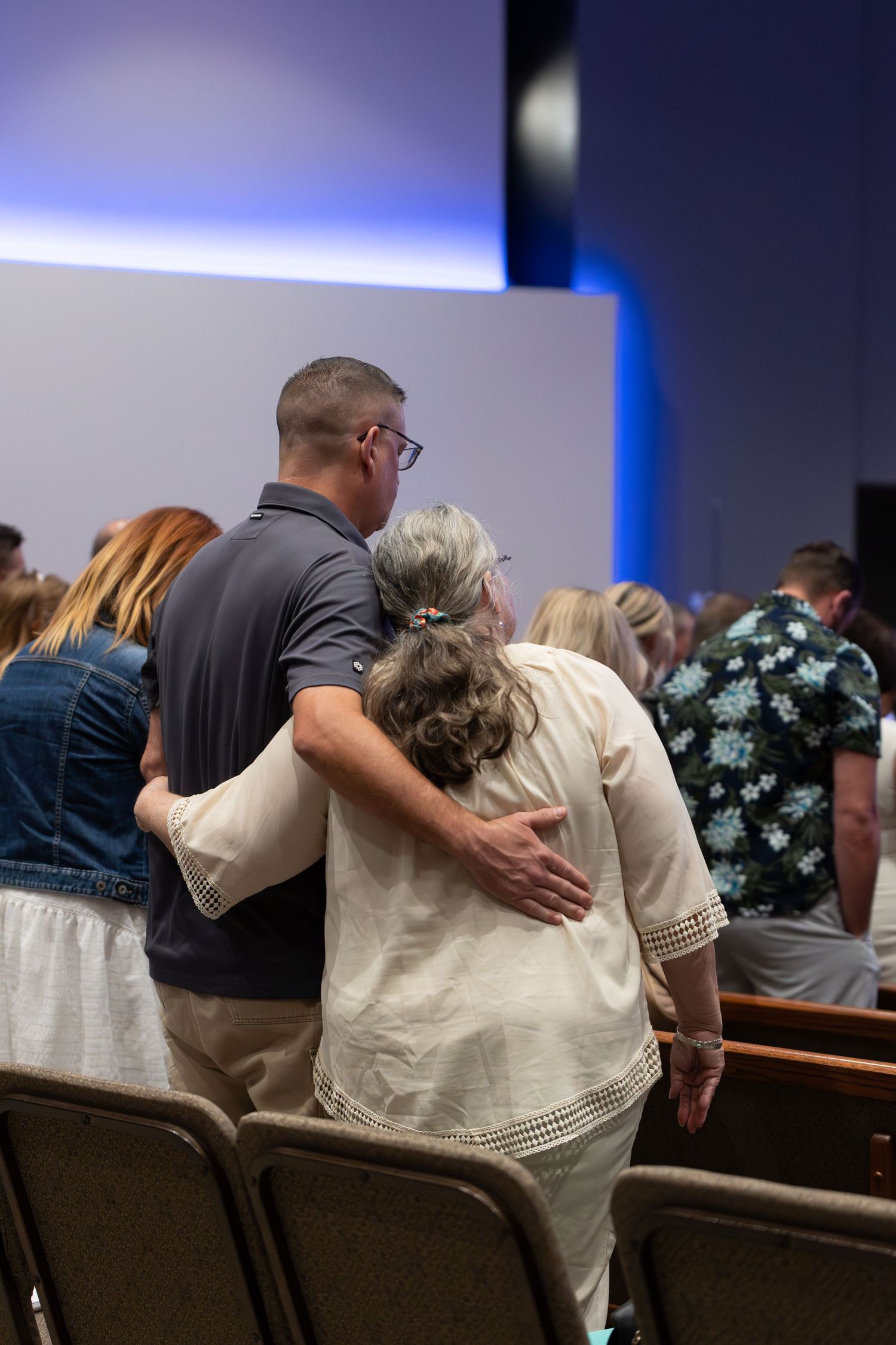 A compassionate moment showing support between church members during a service.