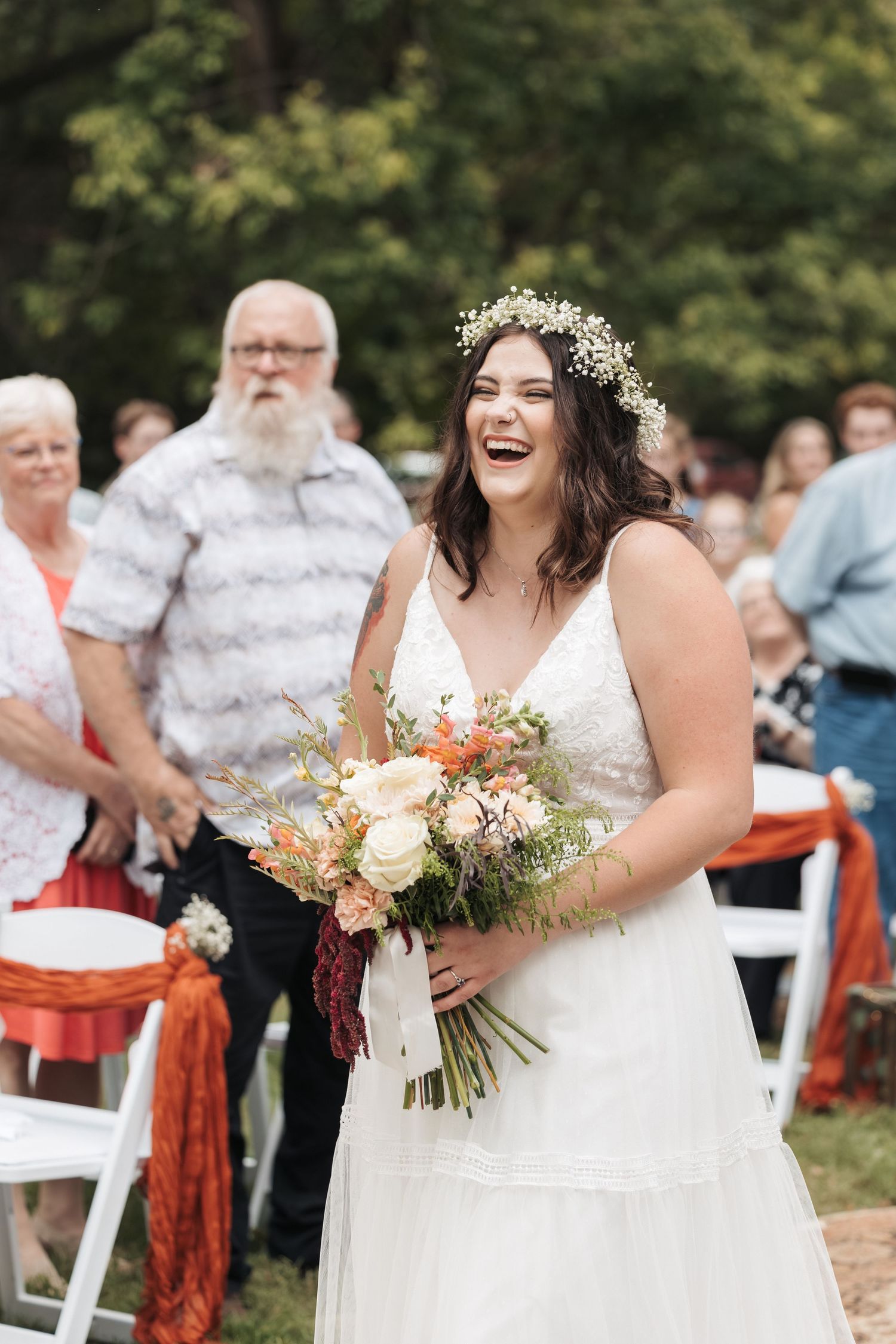 Joyful wedding celebration moment with flower crown and beautiful bouquet.