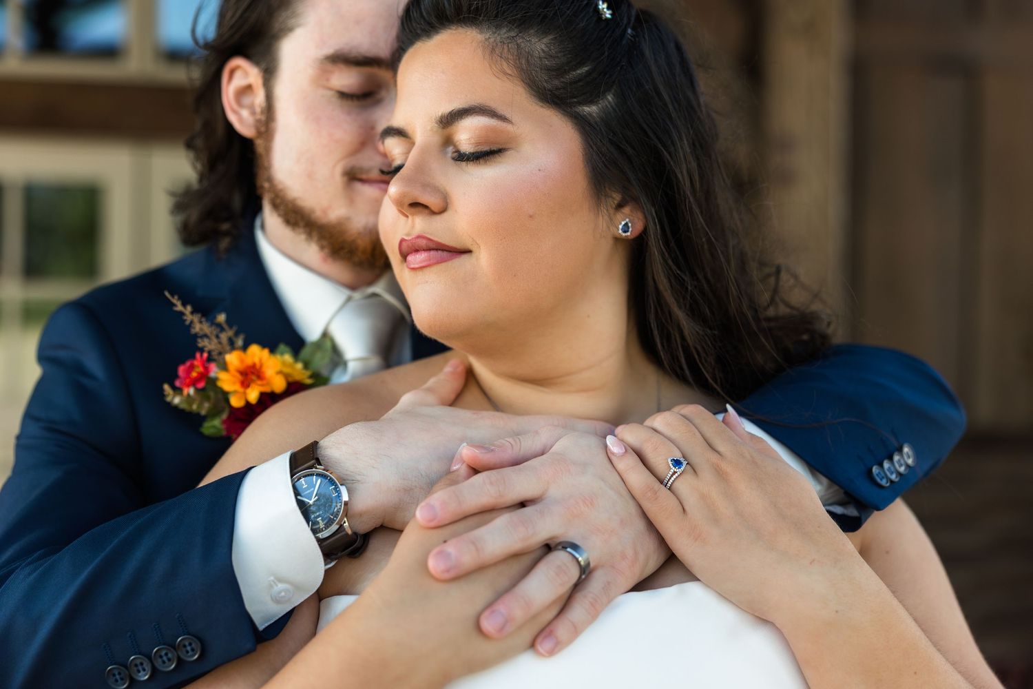 Close-up romantic moments between a couple in navy and white attire during their wedding celebration.