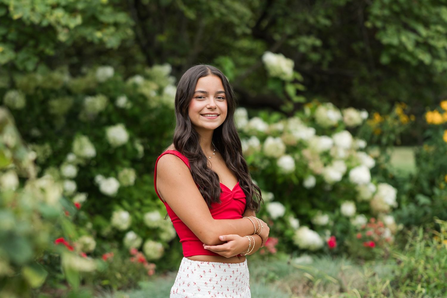A set of portrait shots in a garden with white roses and natural outdoor lighting.