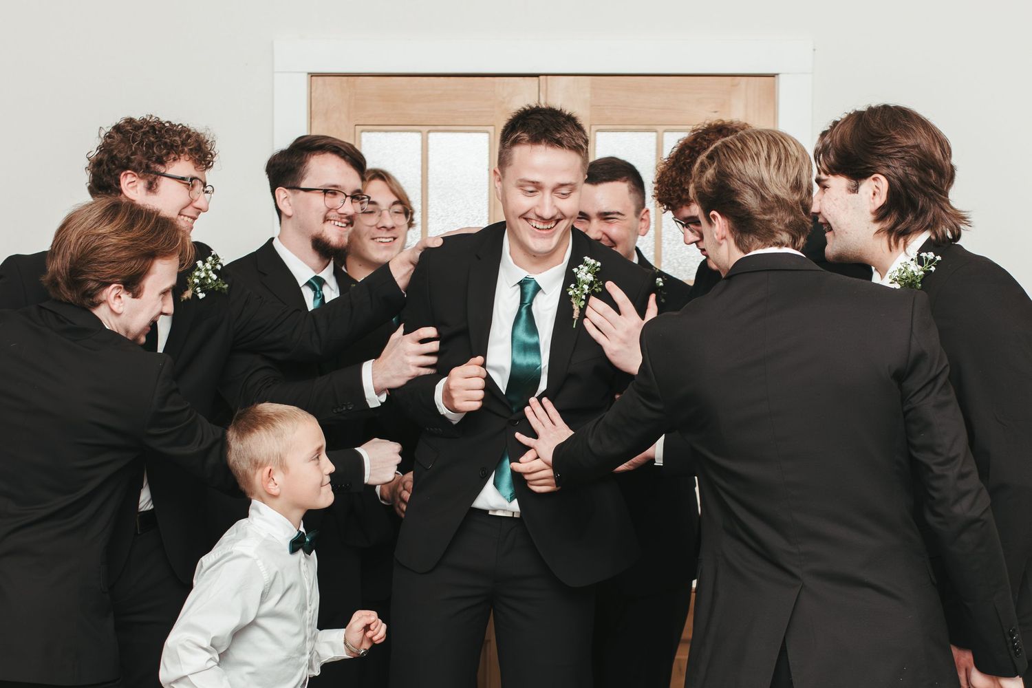 Group in formal attire gathered in laughter and celebration.