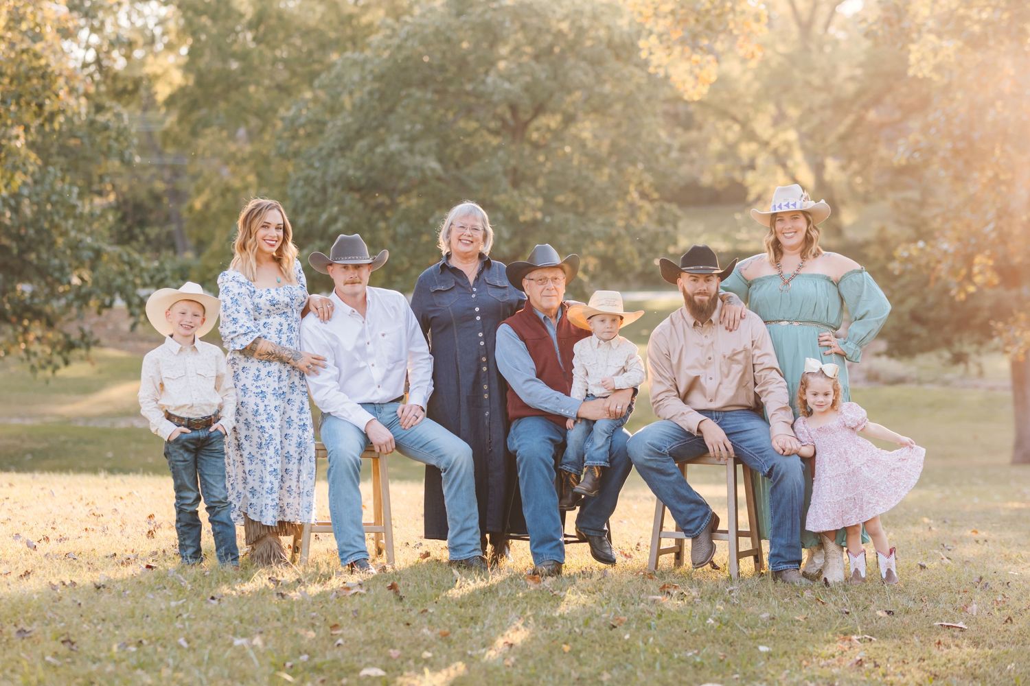 Family members gathered outdoors for a portrait during sunset golden hour.
