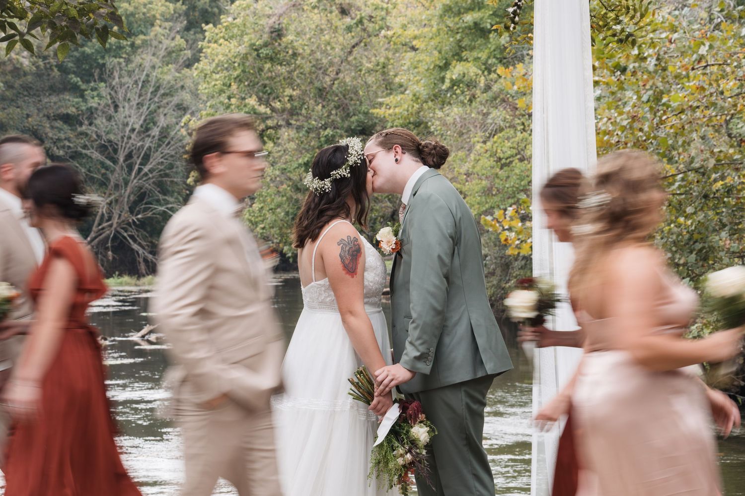 Motion-blur capture of wedding ceremony moments with autumn colors in background.