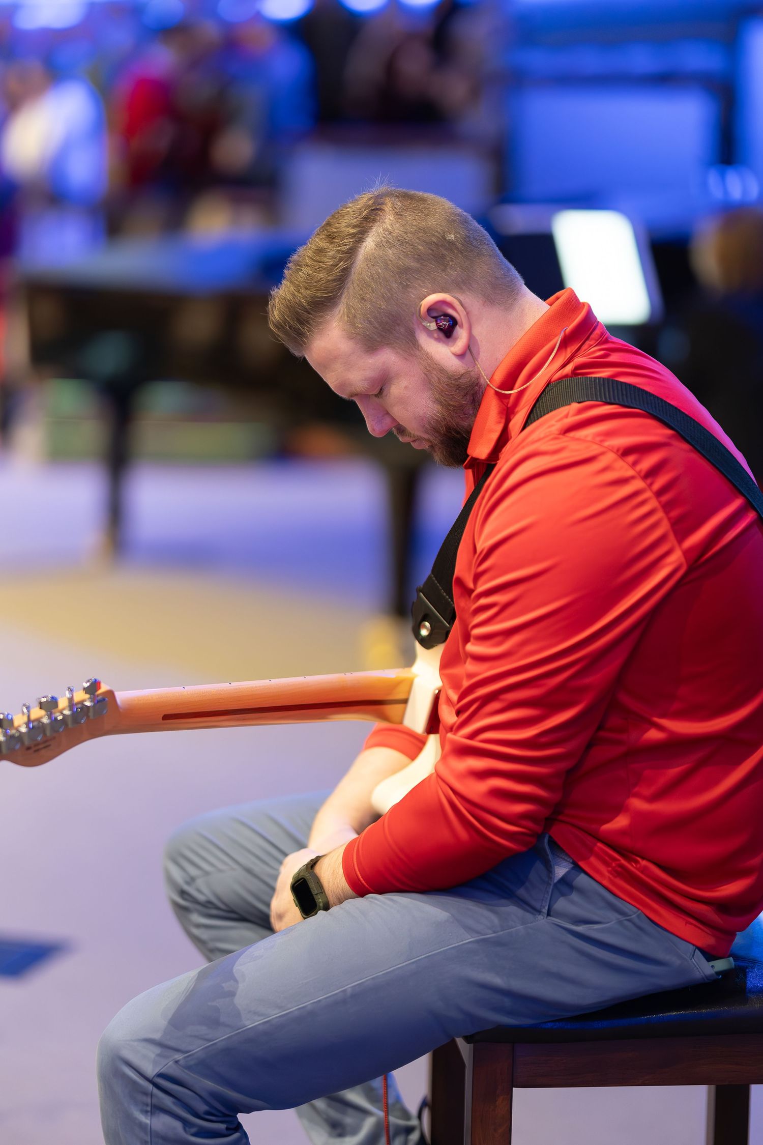 Musician plays guitar during contemporary church worship service.