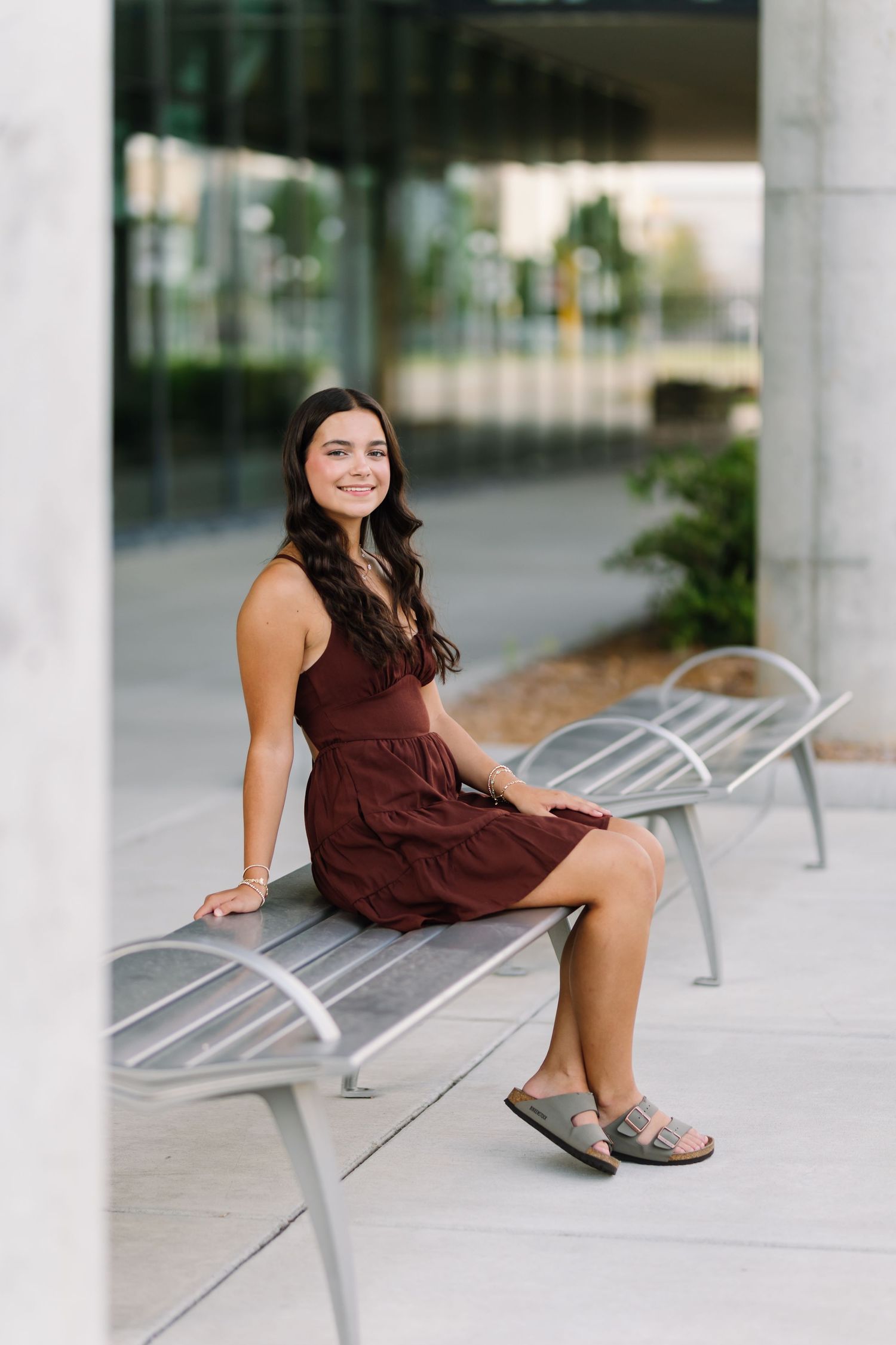 A series of shots on modern metal benches in an urban setting with concrete columns.